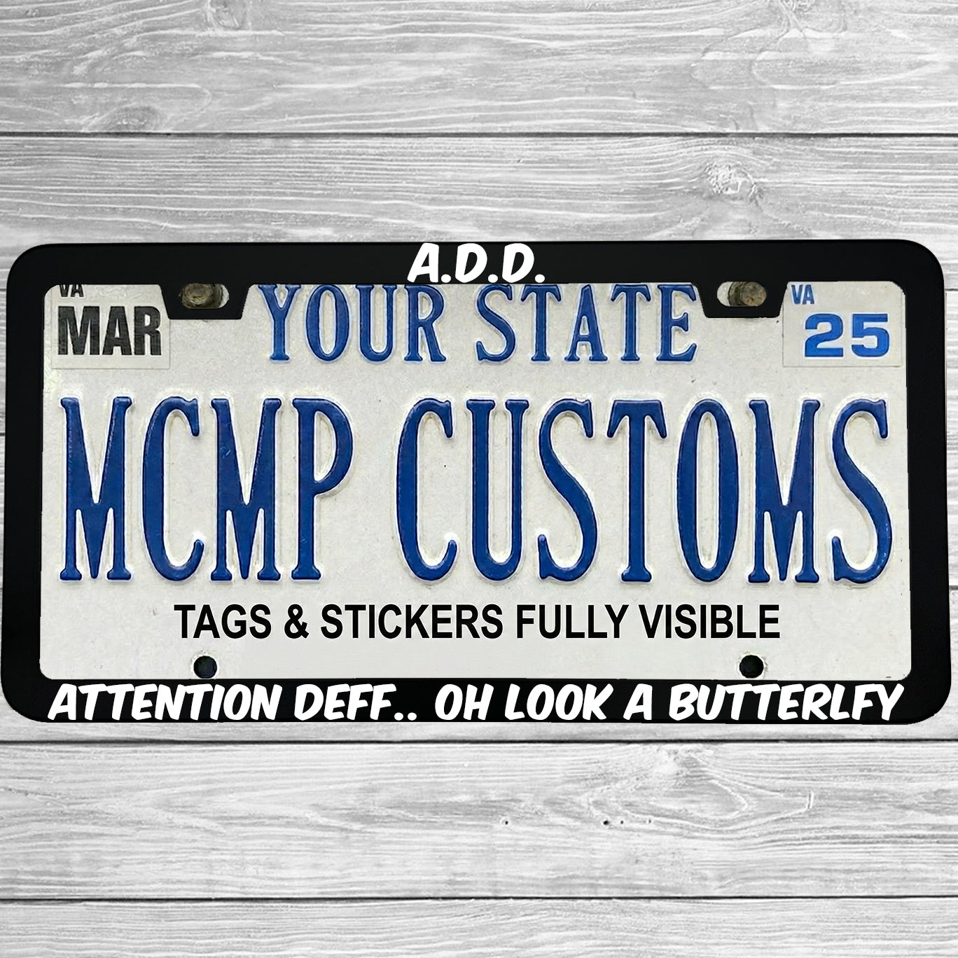 "ADD Attention Def Oh Look A Butterfly" license plate frame shown on vehicle β lifestyle photo