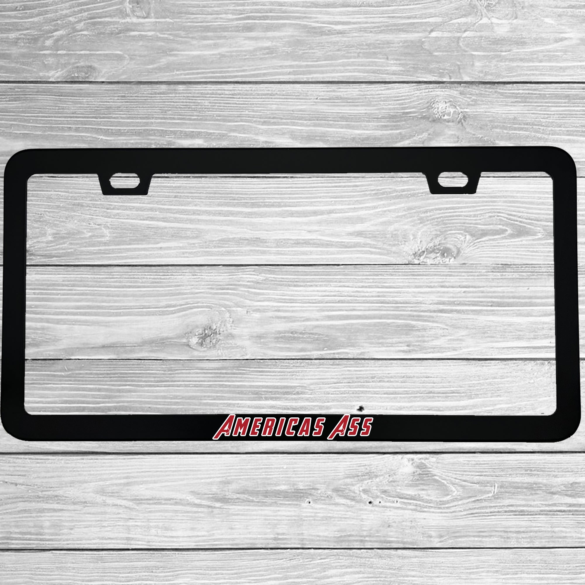 Close-up of "America's Ass" license plate frame showing fade-proof print quality