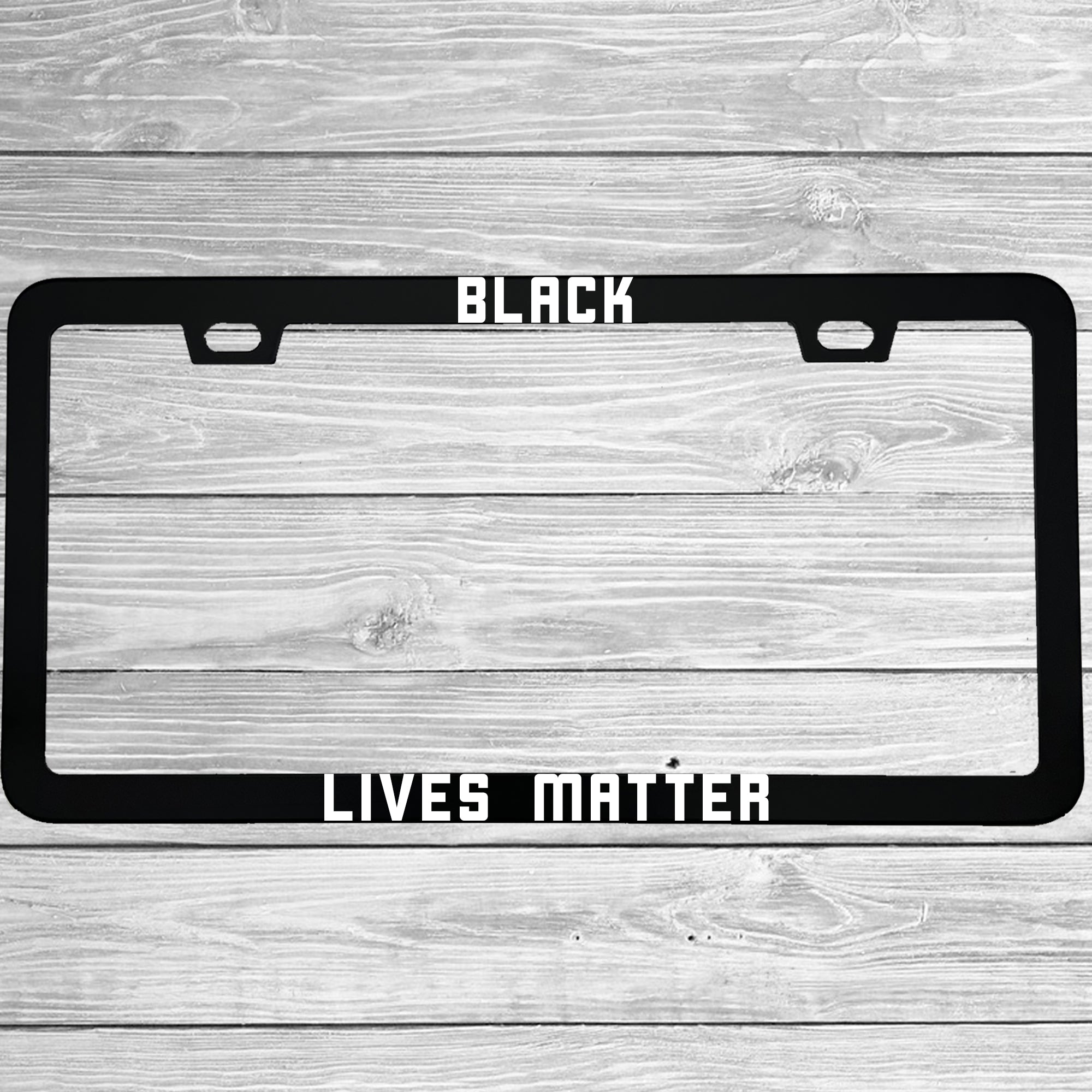 Close-up of "Black Lives Matter" license plate frame showing fade-proof print quality
