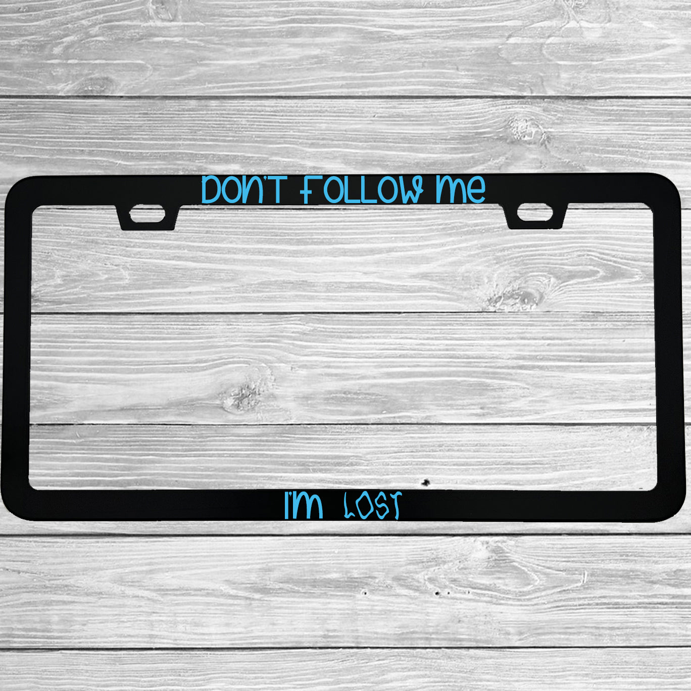 Close-up of "Don't Follow Me I'm Lost" license plate frame showing fade-proof print quality