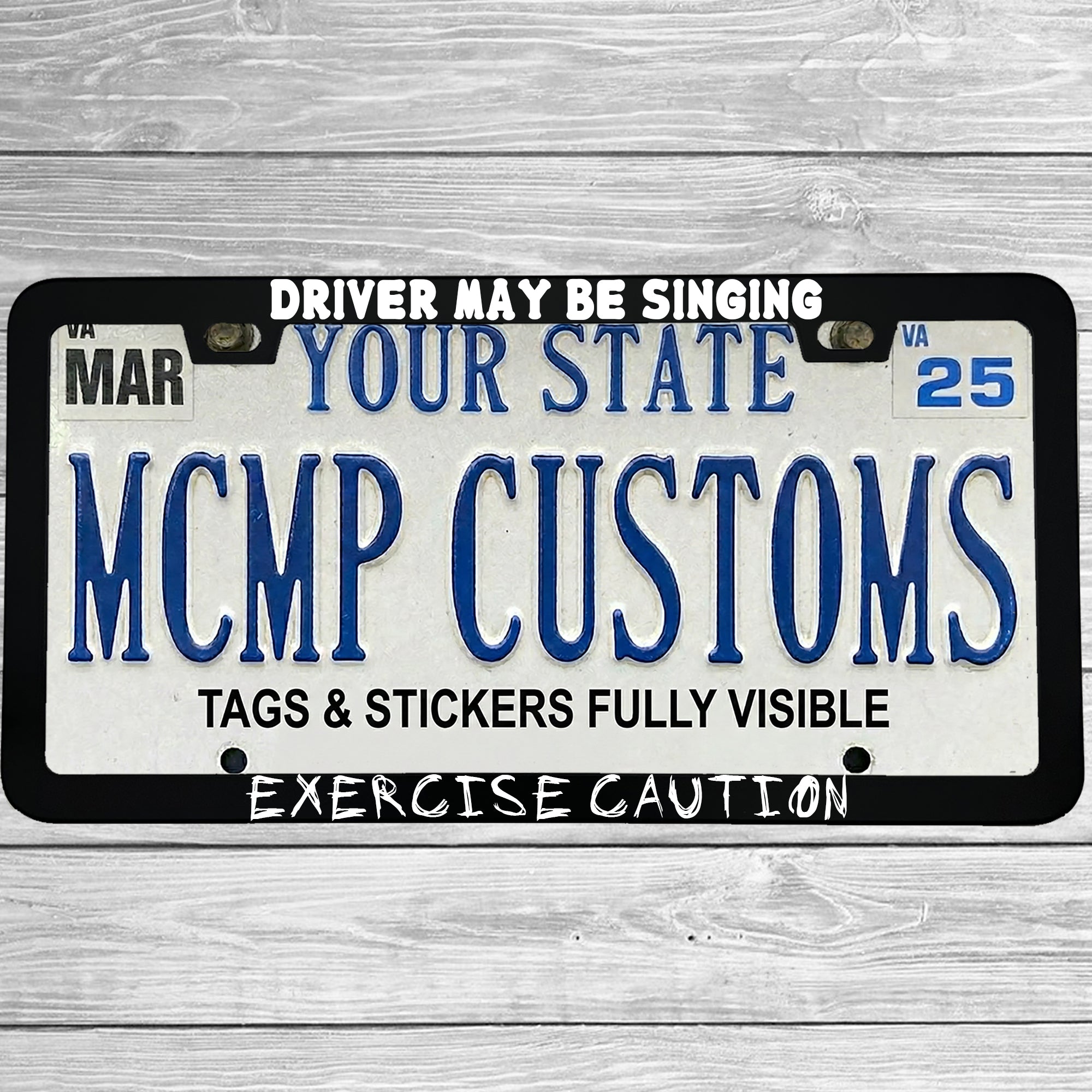 "Driver May Be Singing Exercise Caution" license plate frame shown on vehicle β lifestyle photo