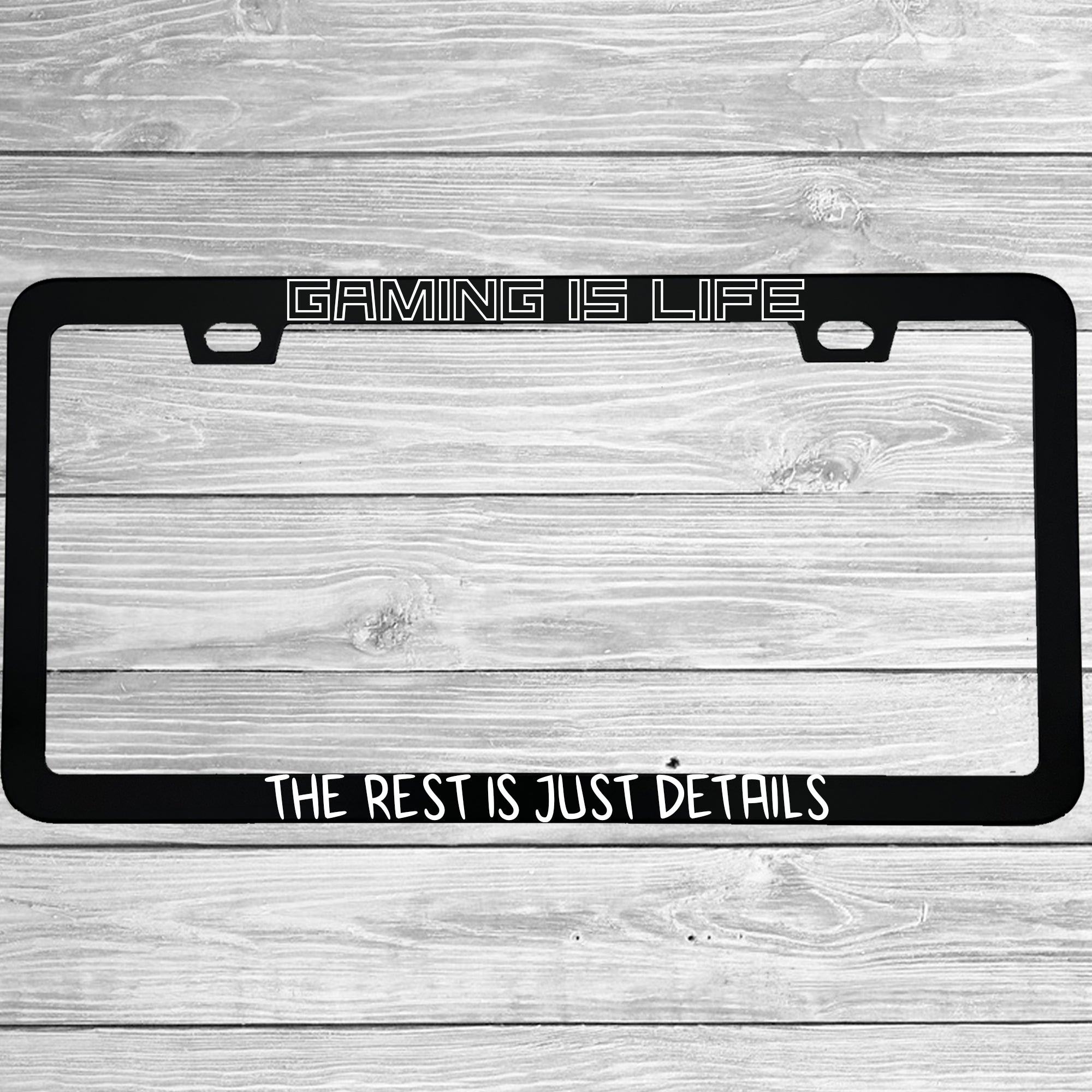 Close-up of "Gaming Is Life The Rest Is Just Details" license plate frame showing fade-proof print quality
