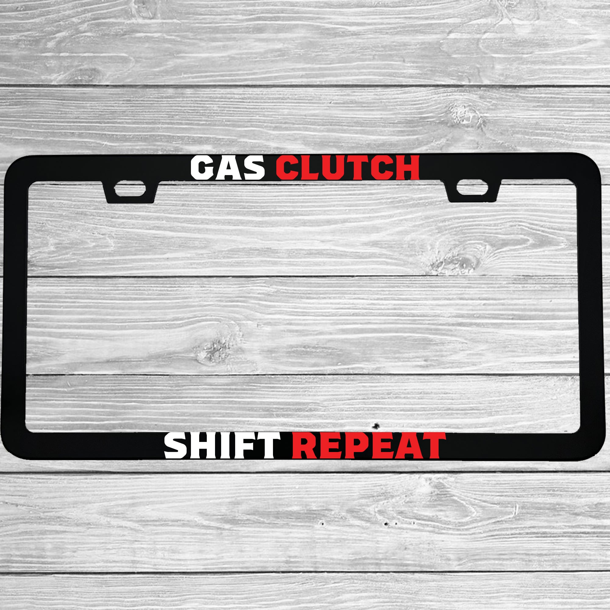 Close-up of "Gas Clutch Shift Repeat" license plate frame showing fade-proof print quality