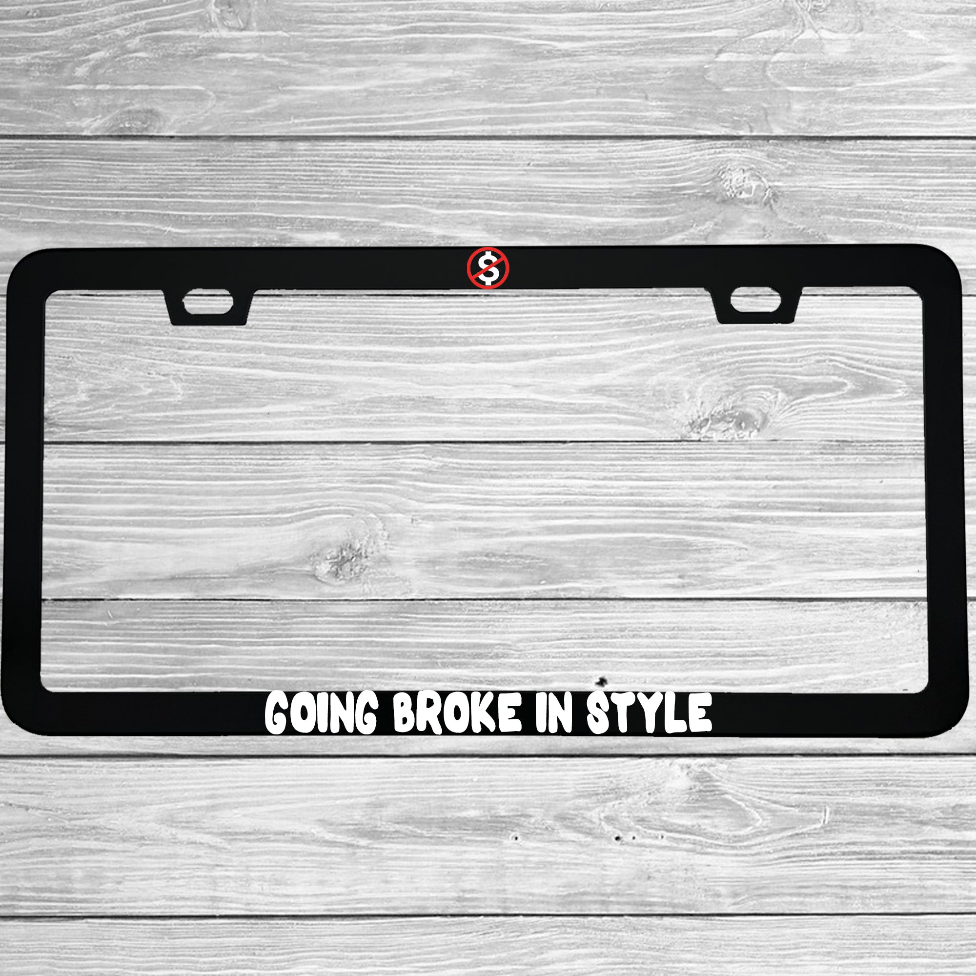 Close-up of "Going Broke In Style" license plate frame showing fade-proof print quality