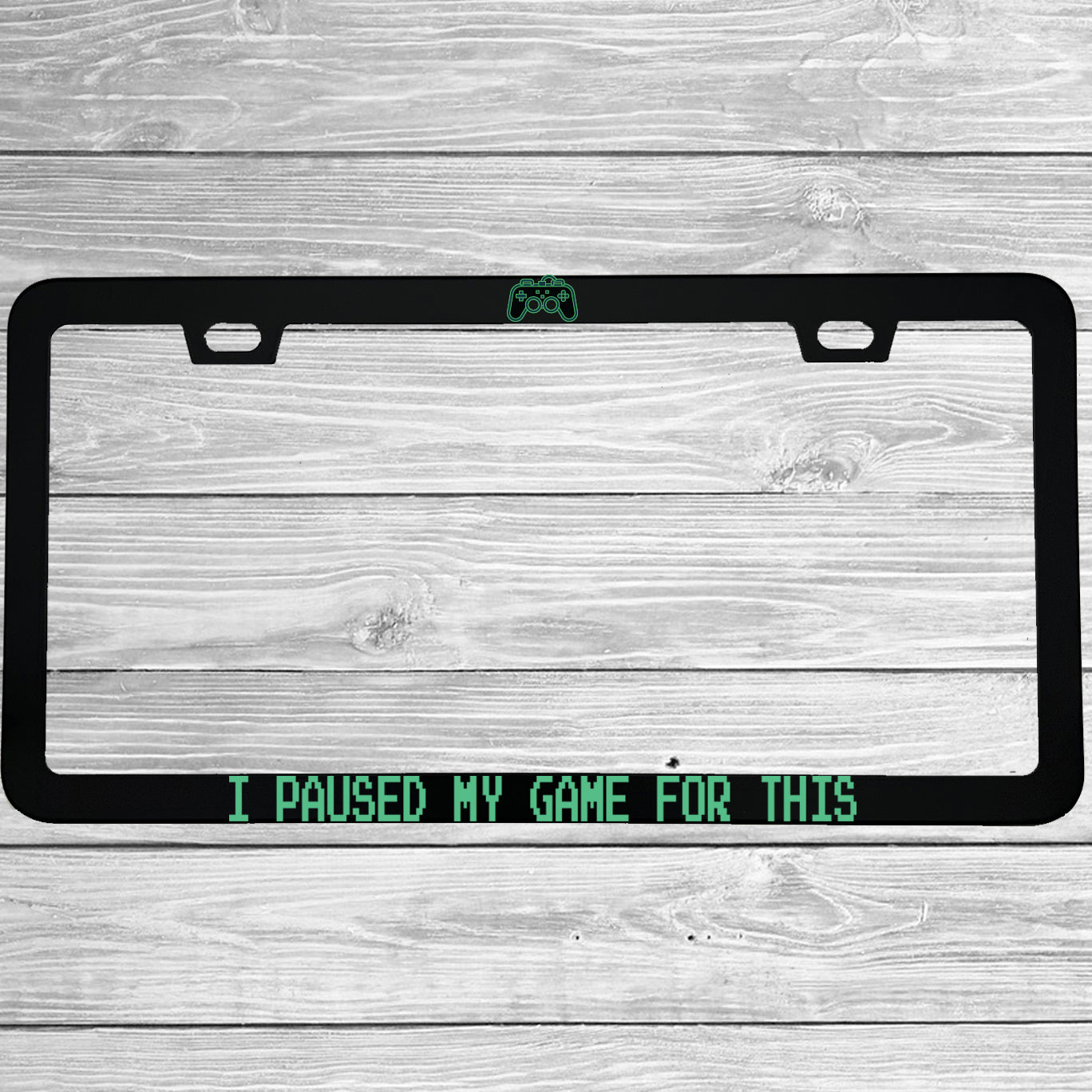 Close-up of "I Paused My Game For This" license plate frame showing fade-proof print quality