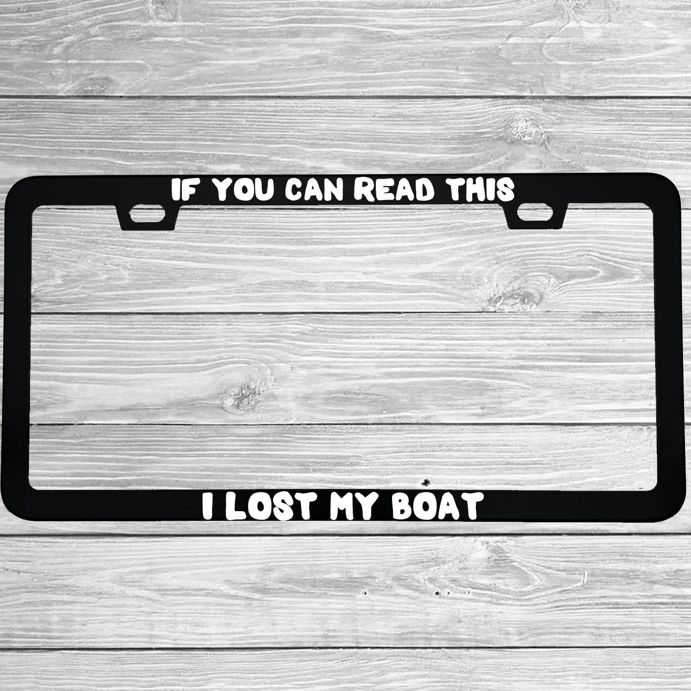 Close-up of "If You Can Read This I Lost My Boat" license plate frame showing fade-proof print quality