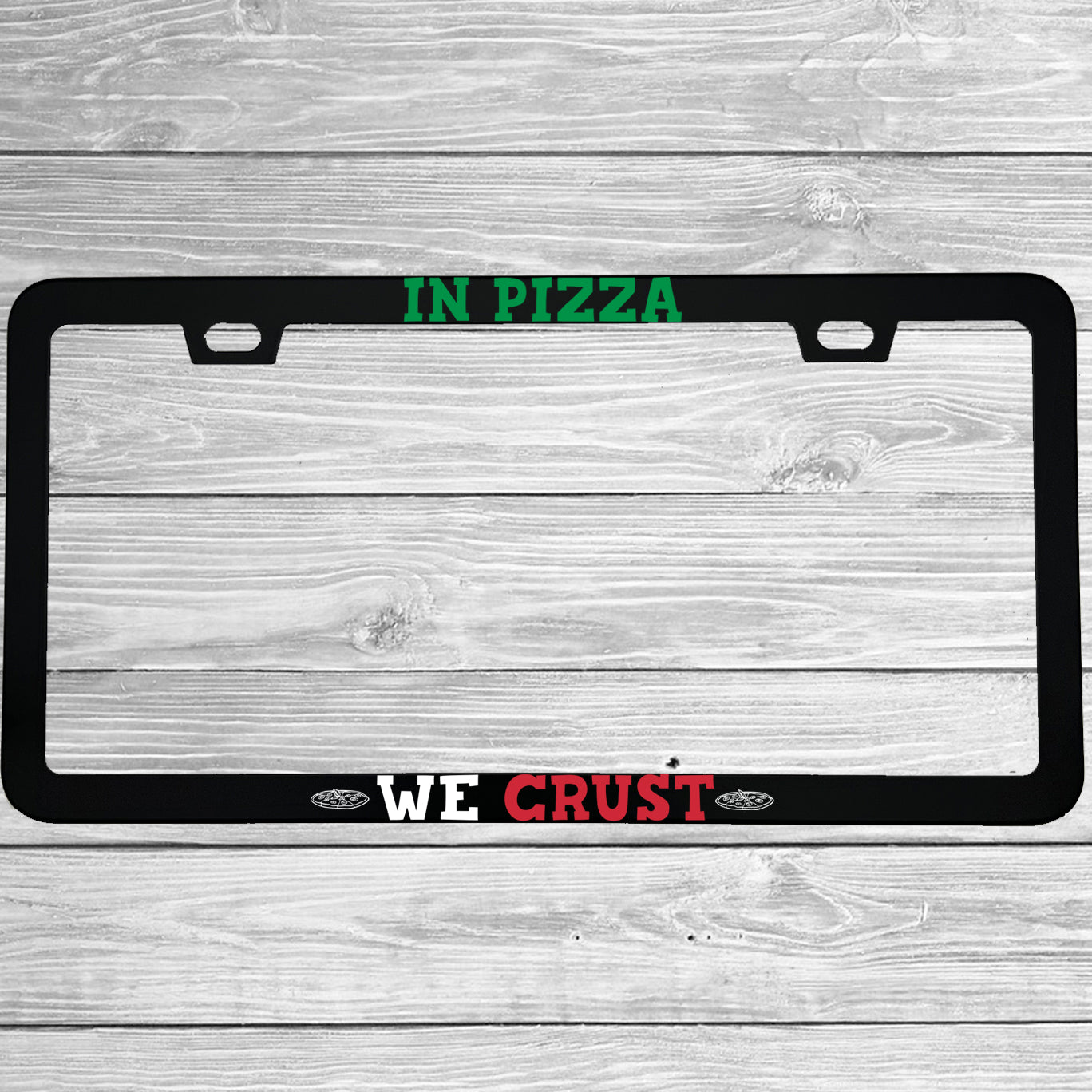 Close-up of "In Pizza We Crust" license plate frame showing fade-proof print quality