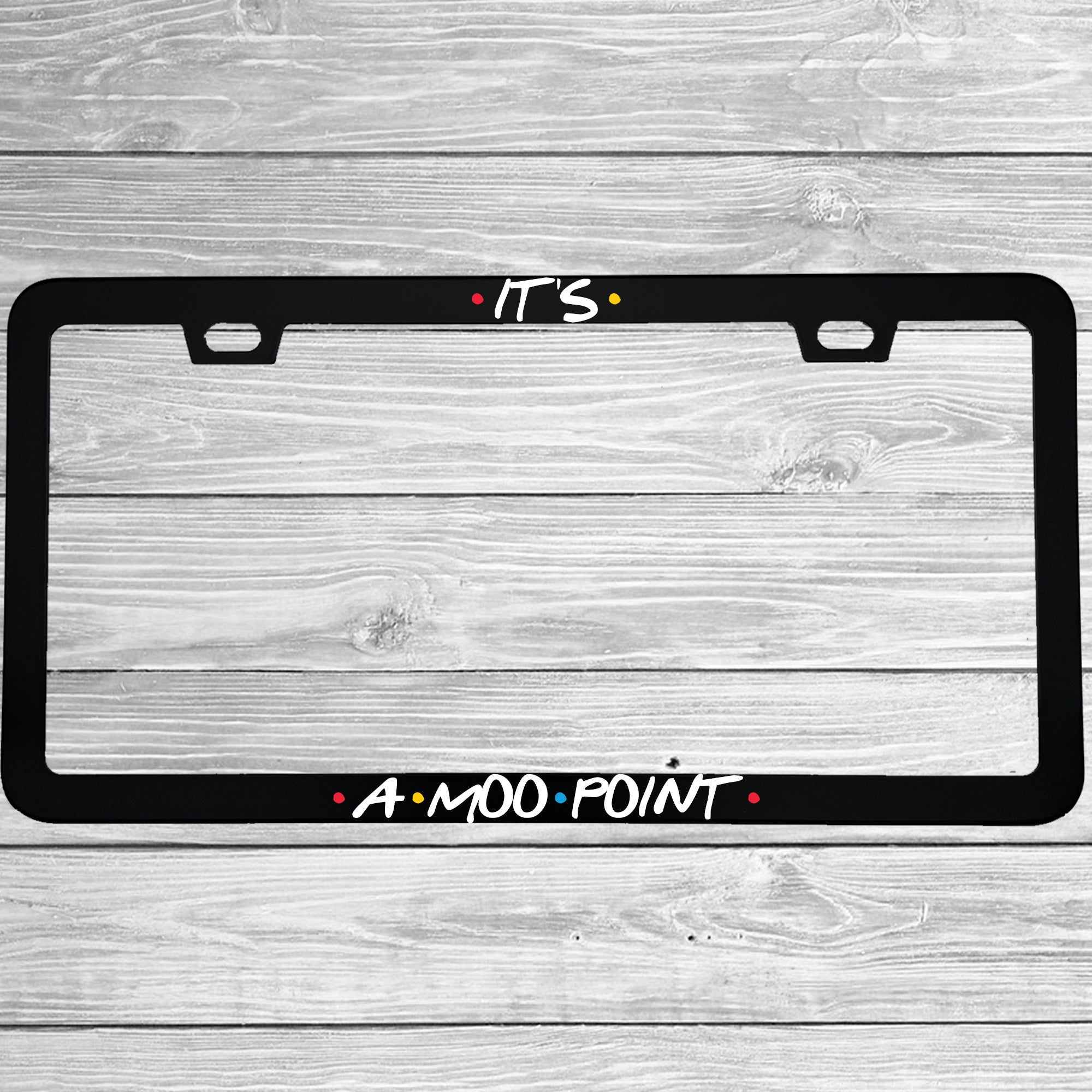 Close-up of "Its A Moo Point" license plate frame showing fade-proof print quality
