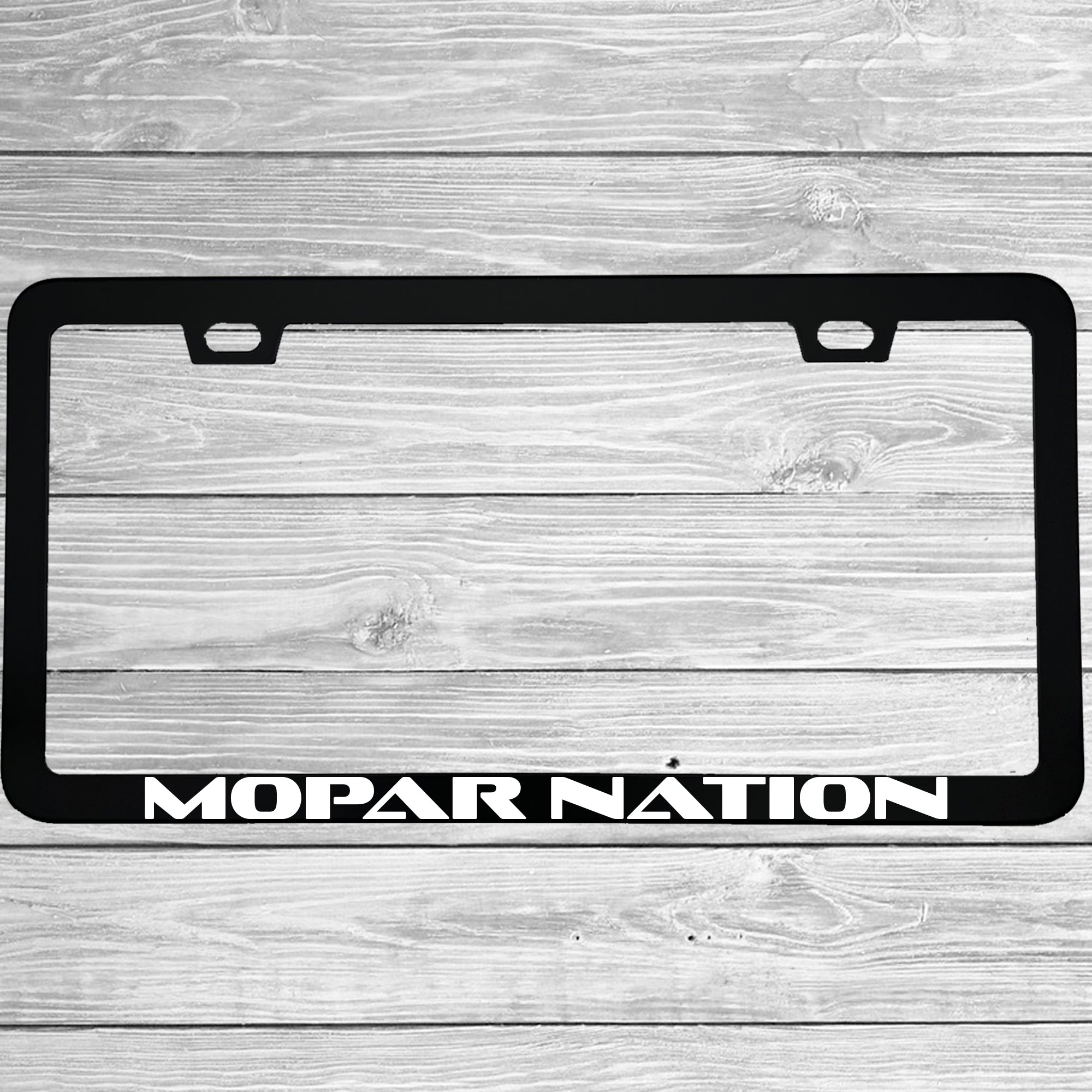 Close-up of "Mopar Nation" license plate frame showing fade-proof print quality