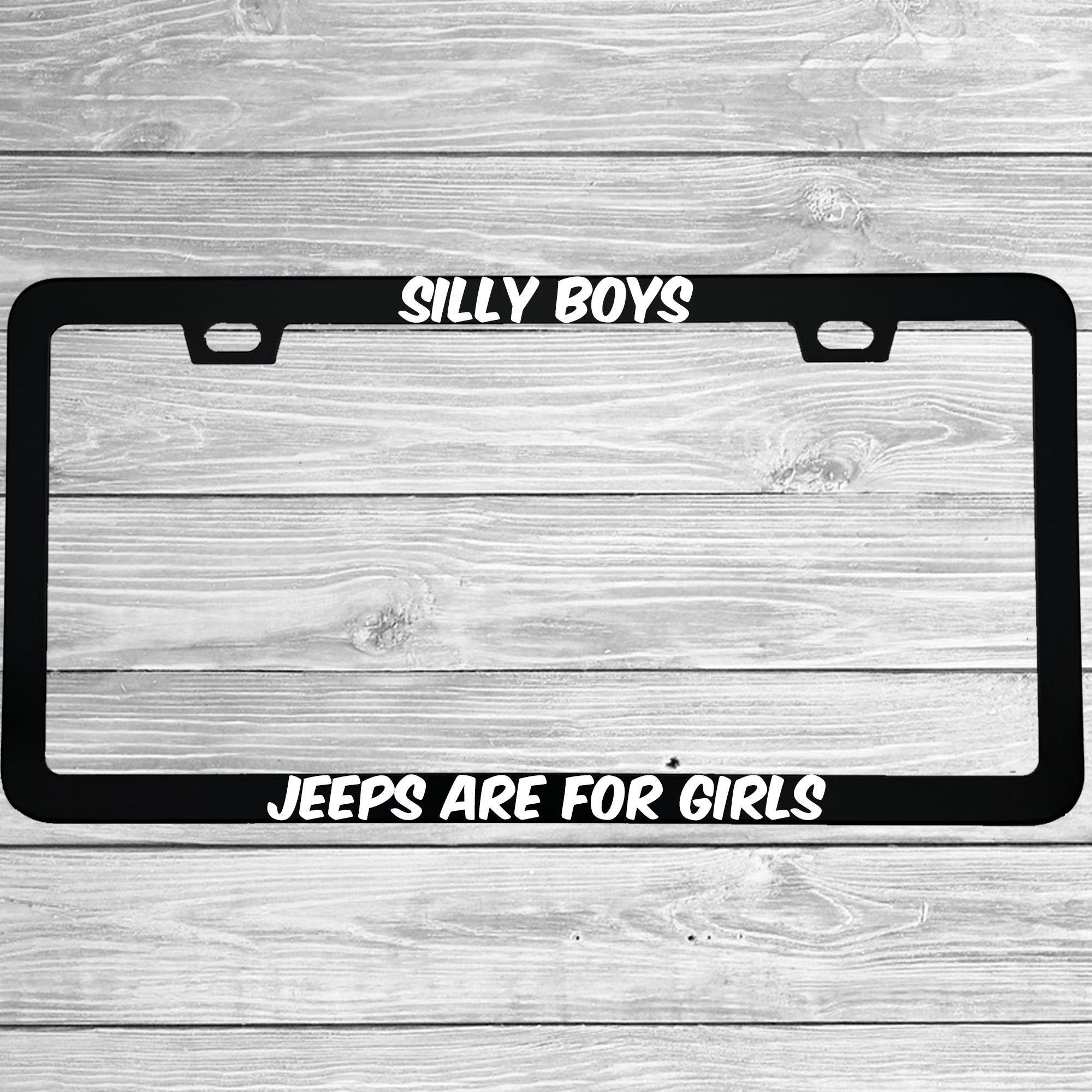Close-up of "Silly Boys Jeeps Are For Girls" license plate frame showing fade-proof print quality