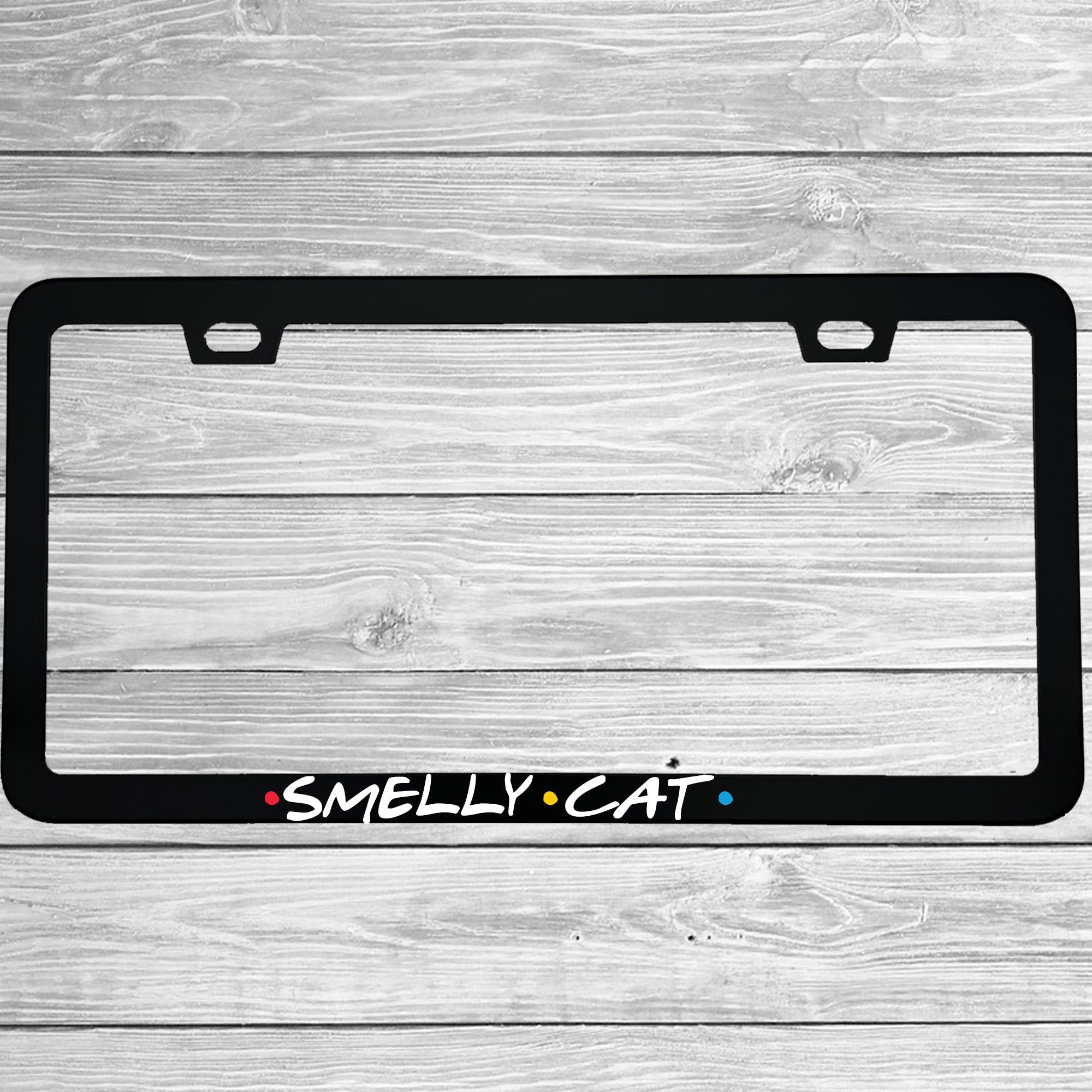 Close-up of "Smelly Cat" license plate frame showing fade-proof print quality