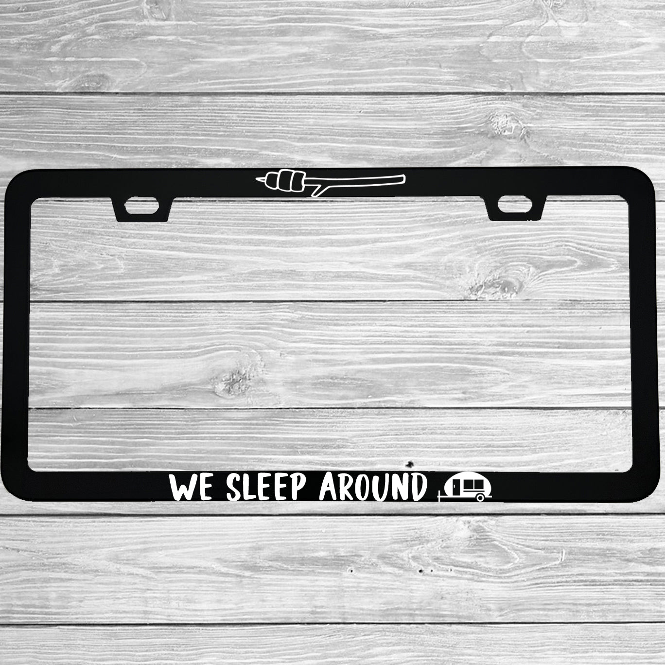 Close-up of "We Sleep Around" license plate frame showing fade-proof print quality