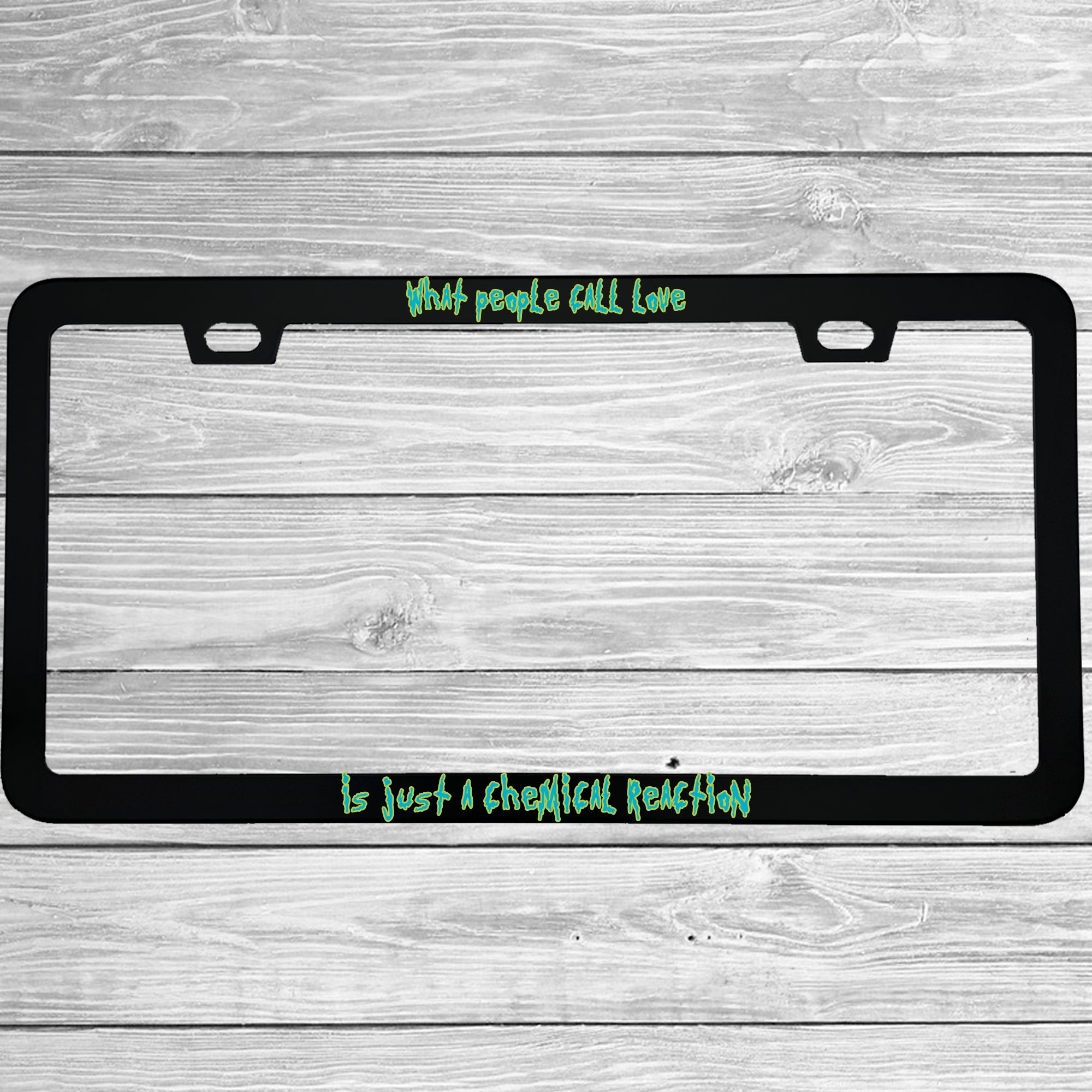 Close-up of "What People Call Love Is Just A Chemical Reaction" license plate frame showing fade-proof print quality