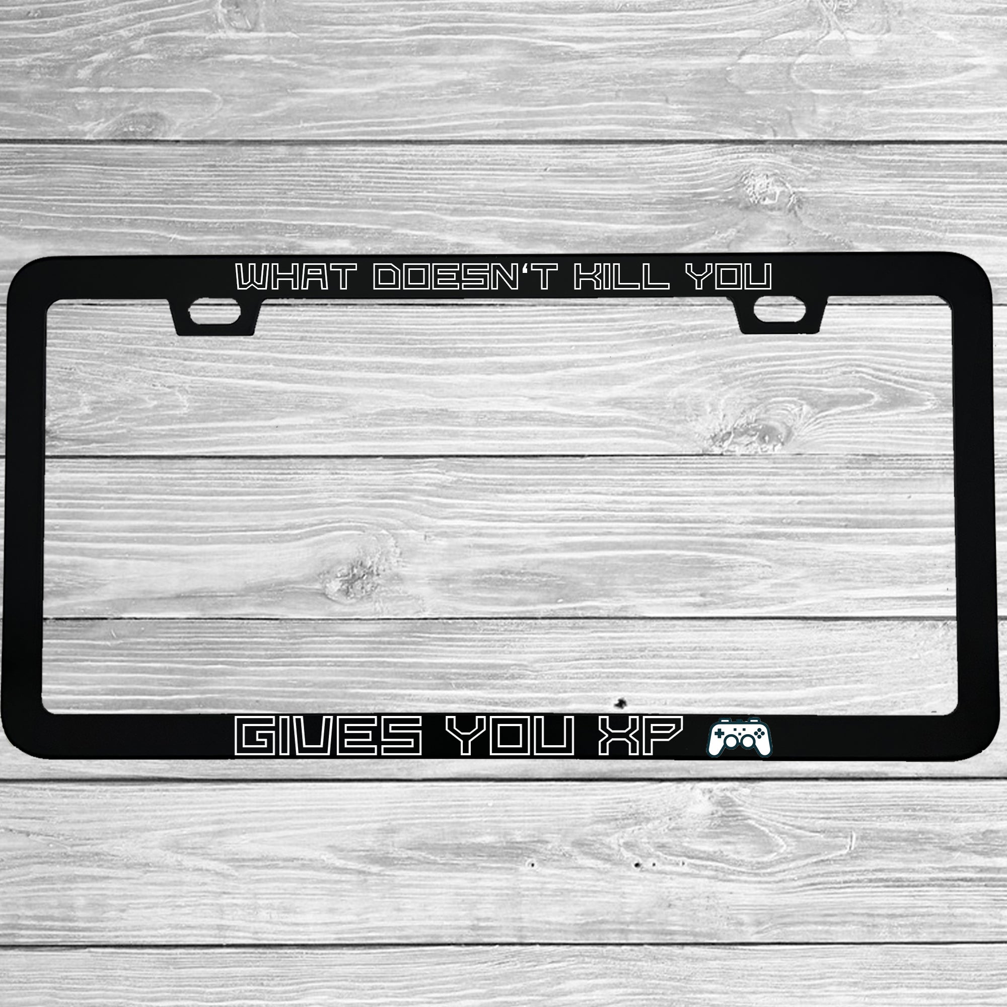 Close-up of "What Doesn't Kill You Gives You XP" license plate frame showing fade-proof print quality