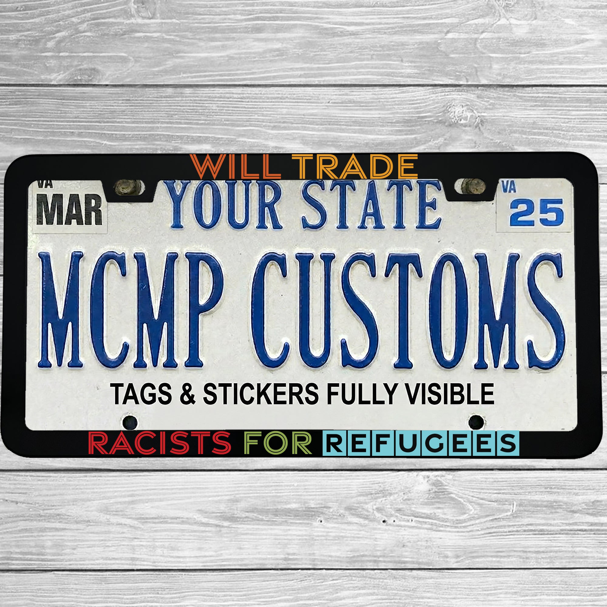 "Will Trade Racists For Refugees" license plate frame shown on vehicle — lifestyle photo