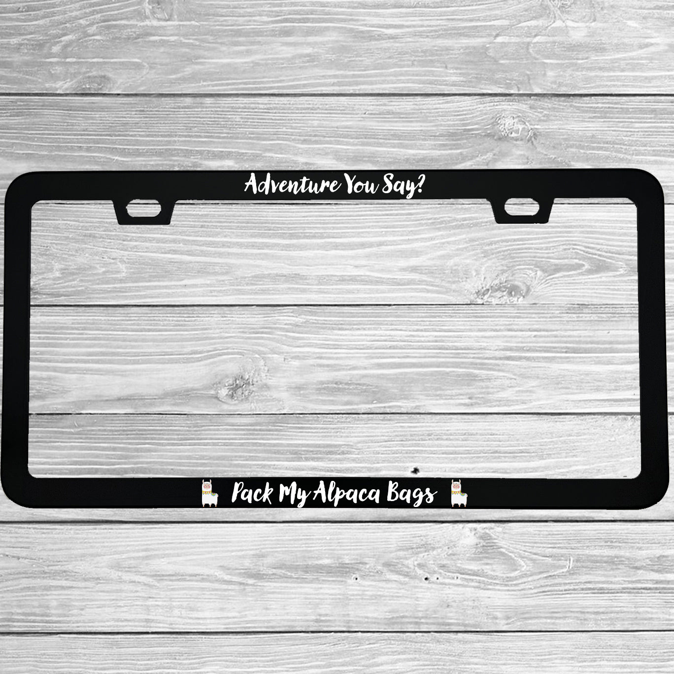 Close-up of "Adventure You Say Pack My Alpaca Bags" license plate frame showing fade-proof print quality