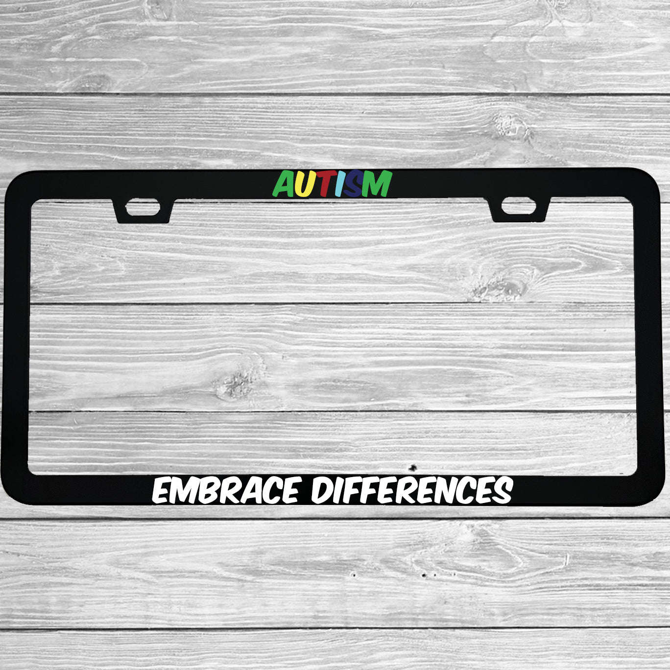 Close-up of "Autism Embrace Differences" license plate frame showing fade-proof print quality