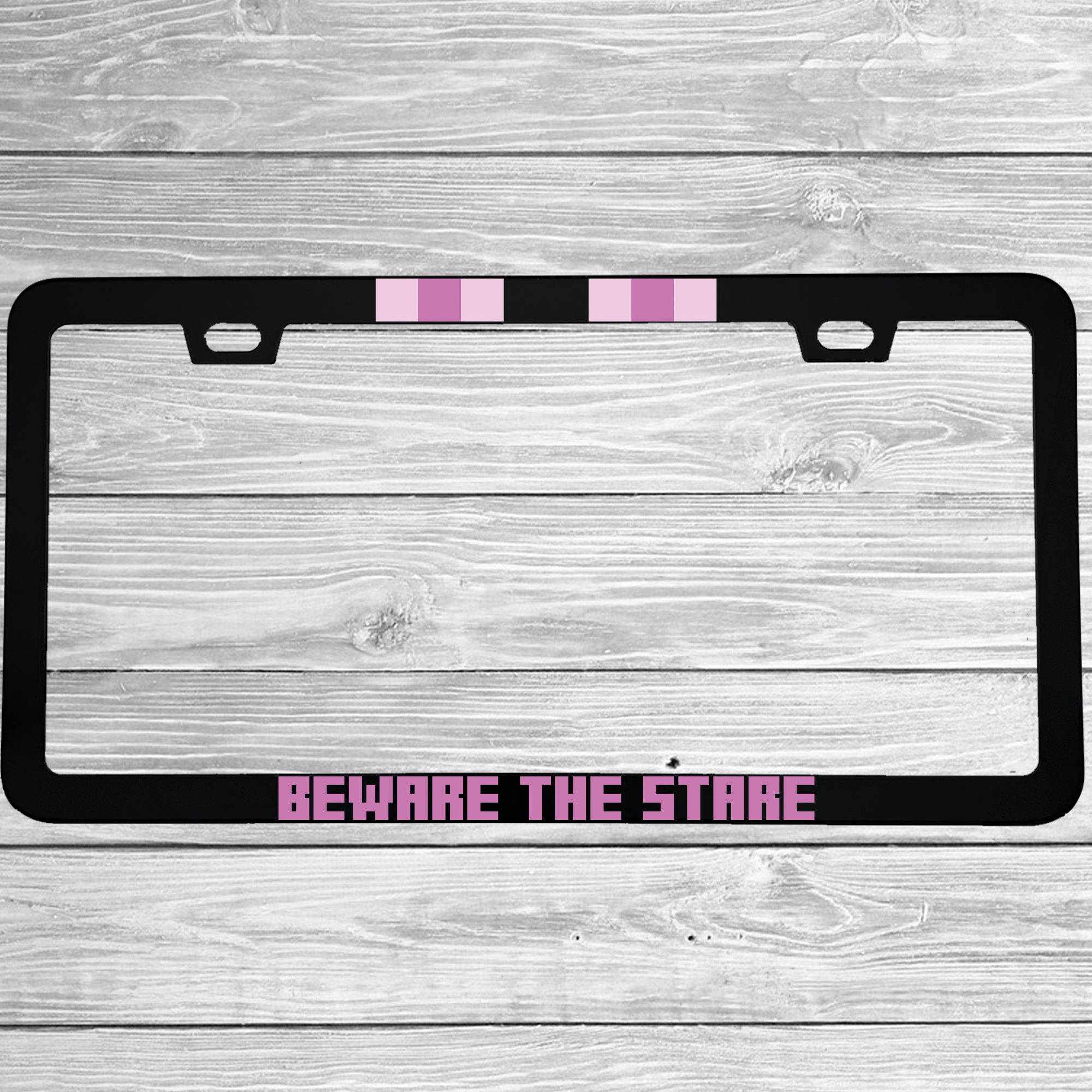 Close-up of "Beware The Stare" license plate frame showing fade-proof print quality