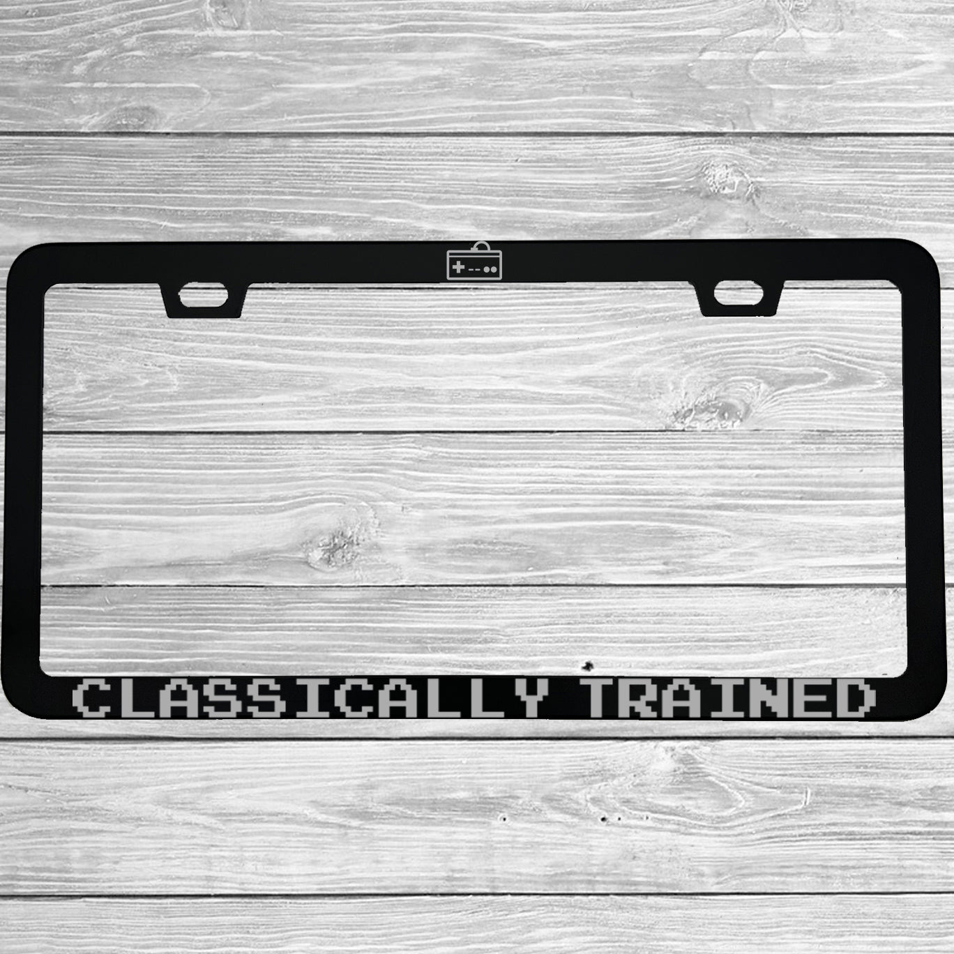 Close-up of "Classically Trained" license plate frame showing fade-proof print quality