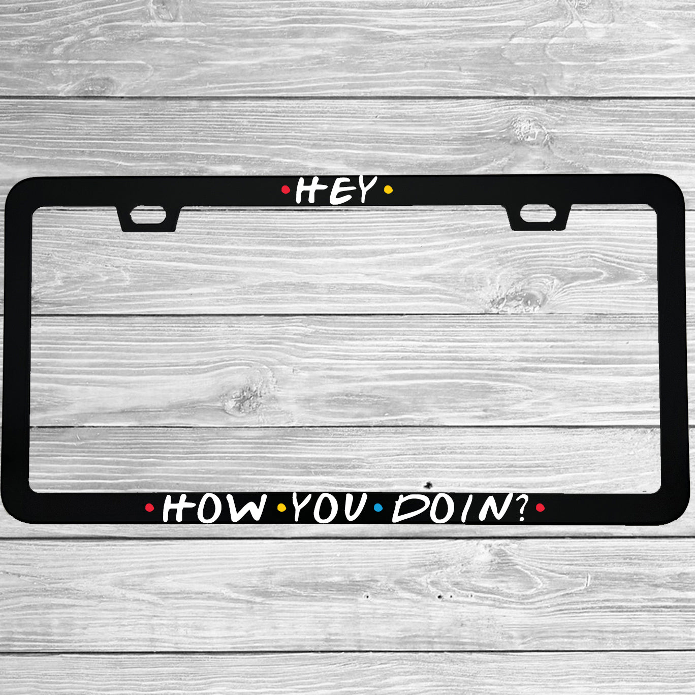 Close-up of "Hey How You Doin" license plate frame showing fade-proof print quality