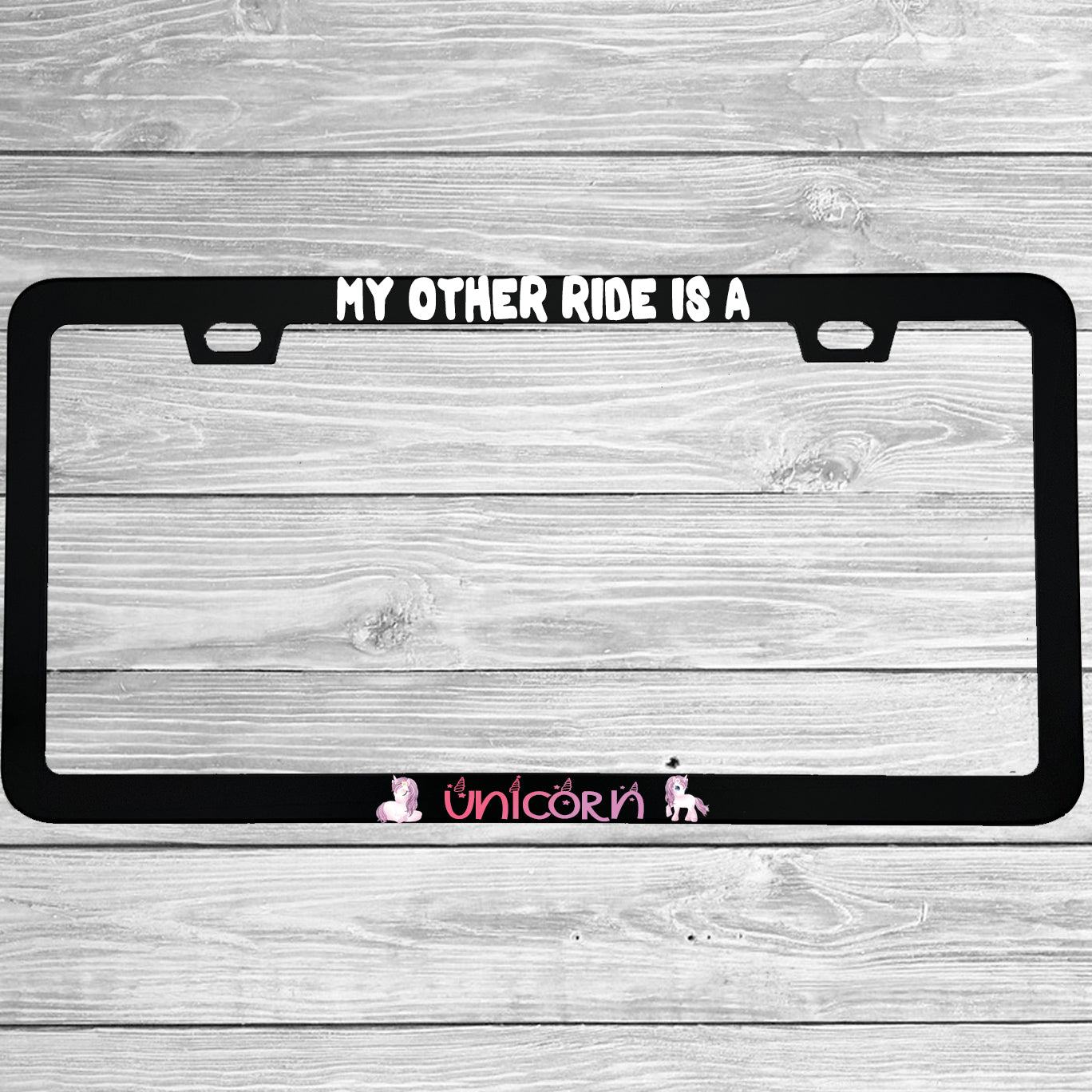 Close-up of "My Other Ride Is A Unicorn" license plate frame showing fade-proof print quality