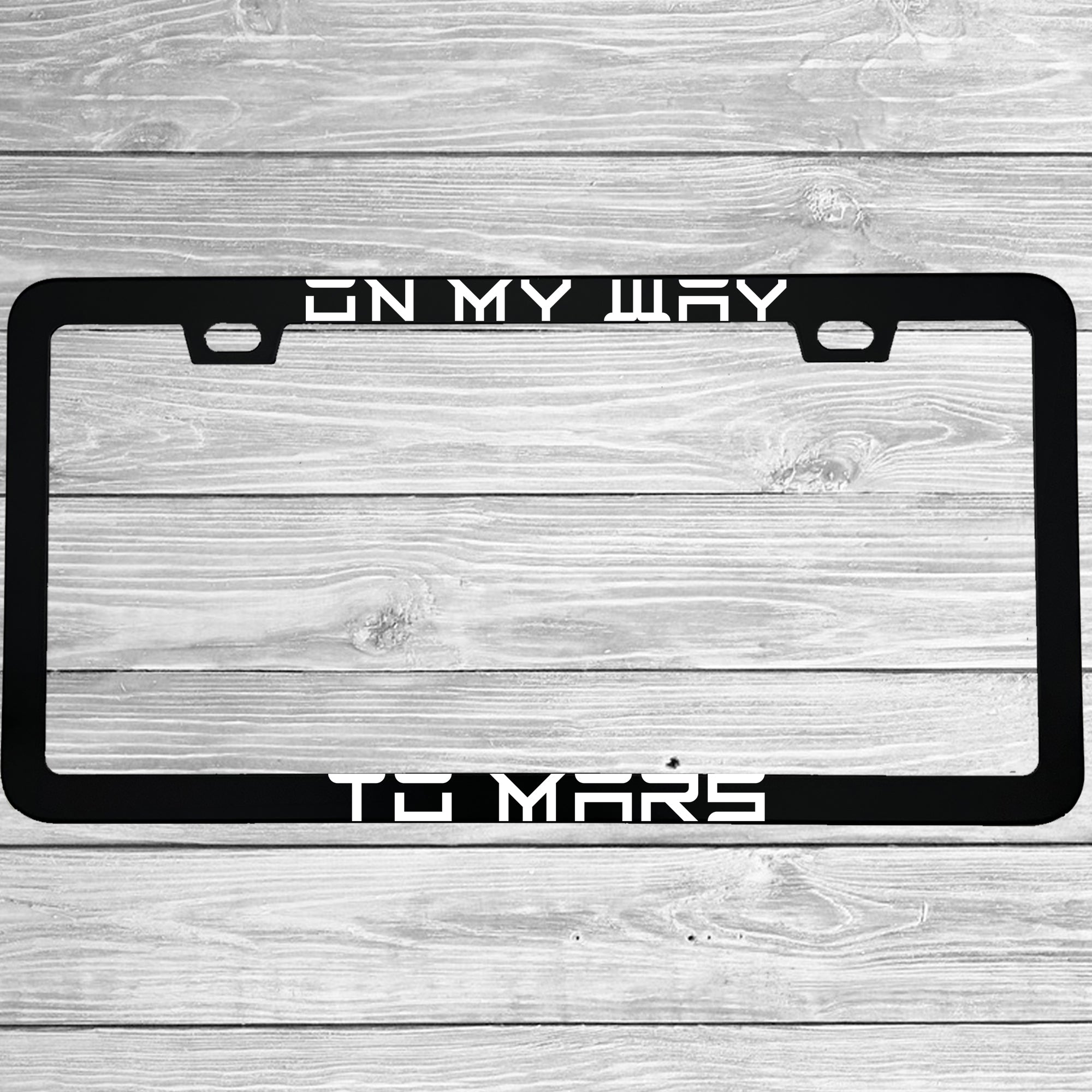 Close-up of "On My Way To Mars Funny Electric Car Outer Space Themed" license plate frame showing fade-proof print quality