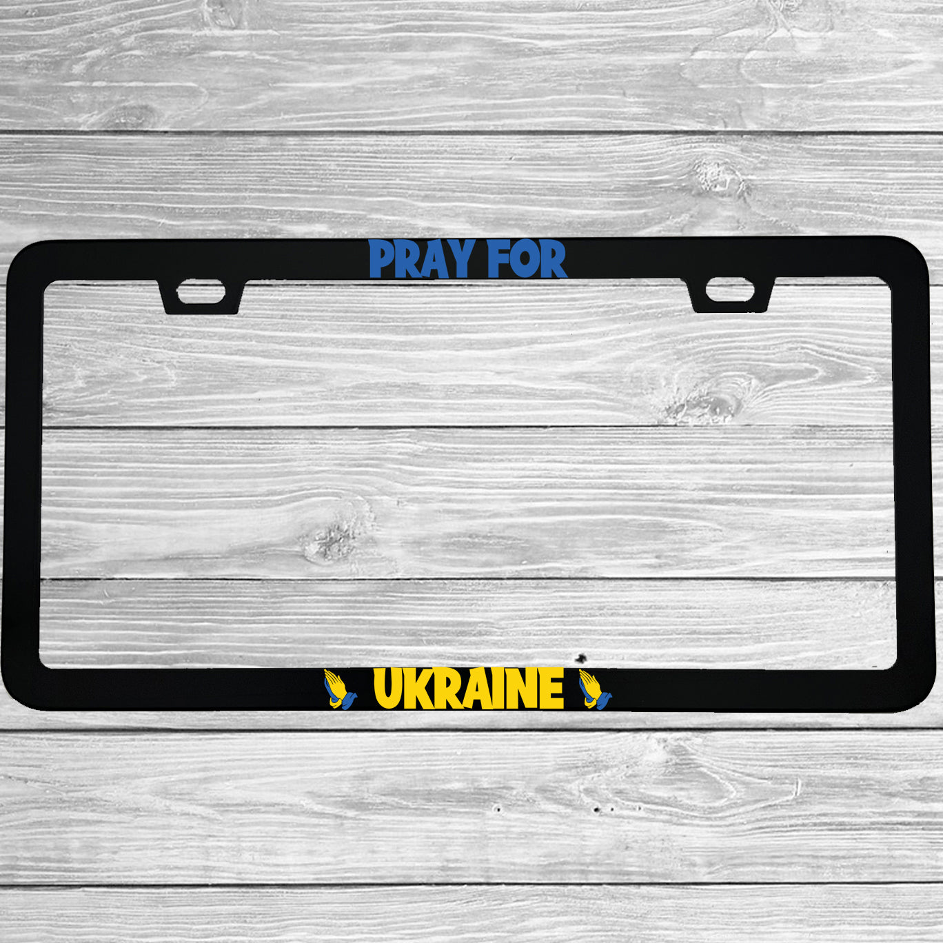 Close-up of "Pray For Ukraine" license plate frame showing fade-proof print quality