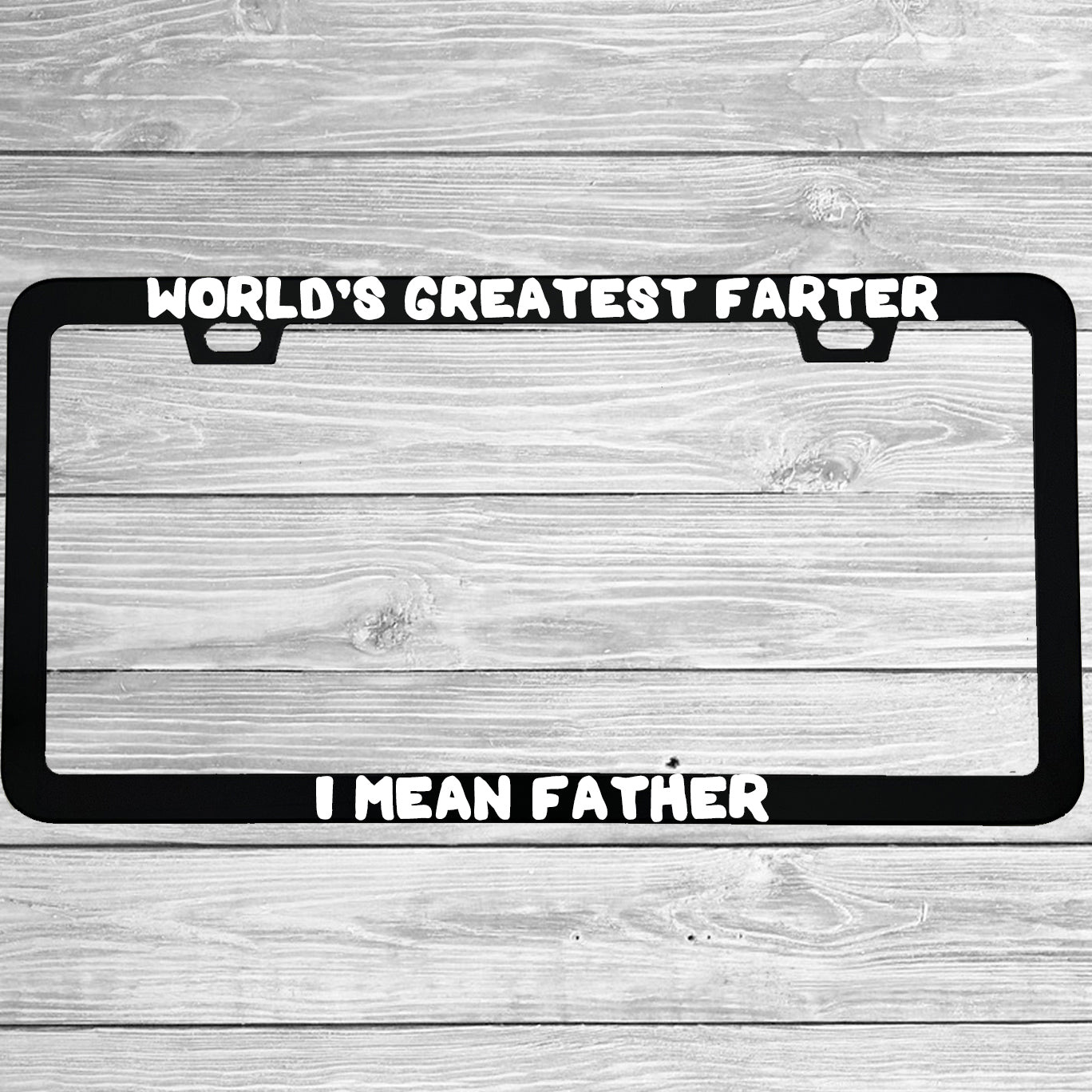 Close-up of "World's Greatest Farter I Mean Father" license plate frame showing fade-proof print quality