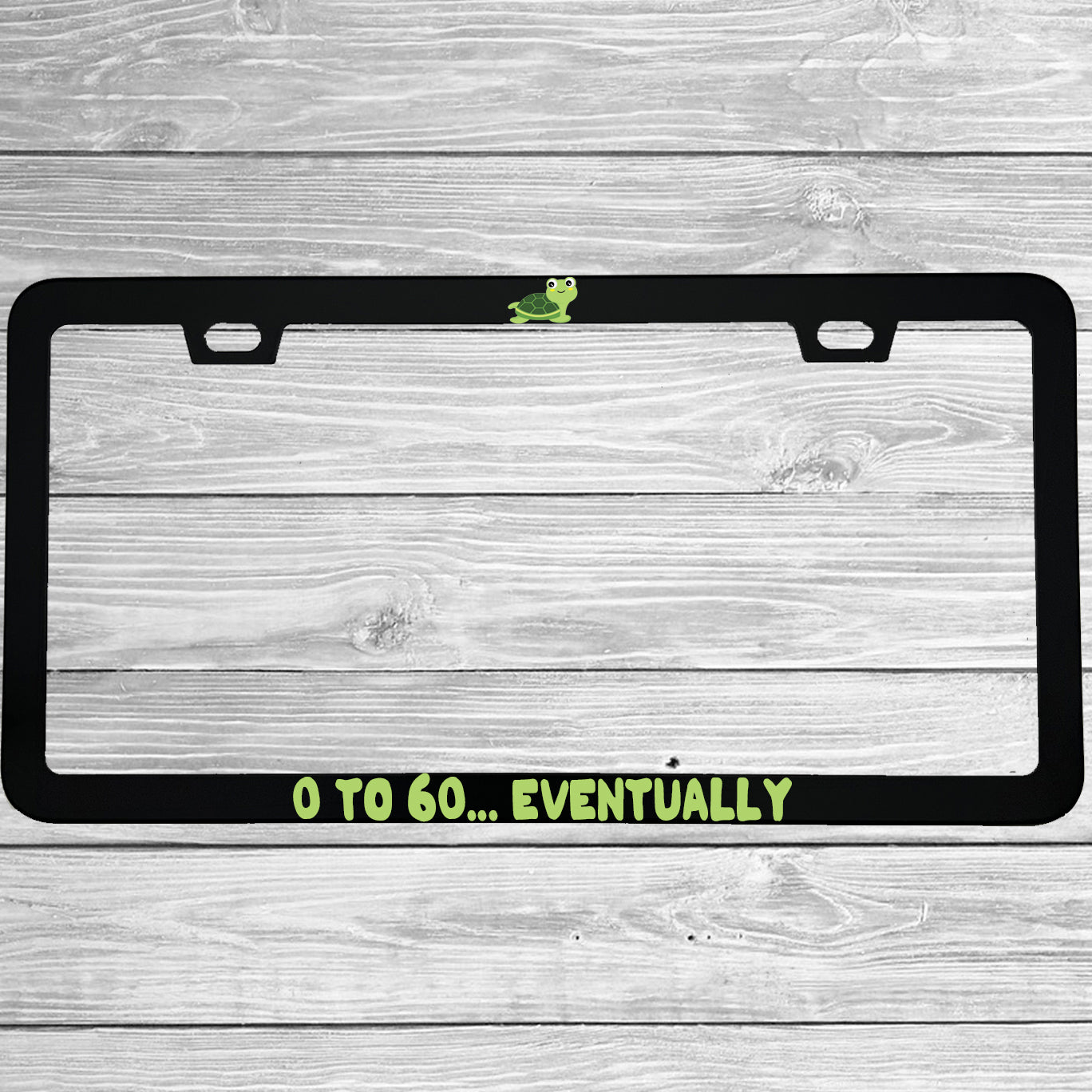 Close-up of "0 To 60 Eventually" license plate frame showing fade-proof print quality