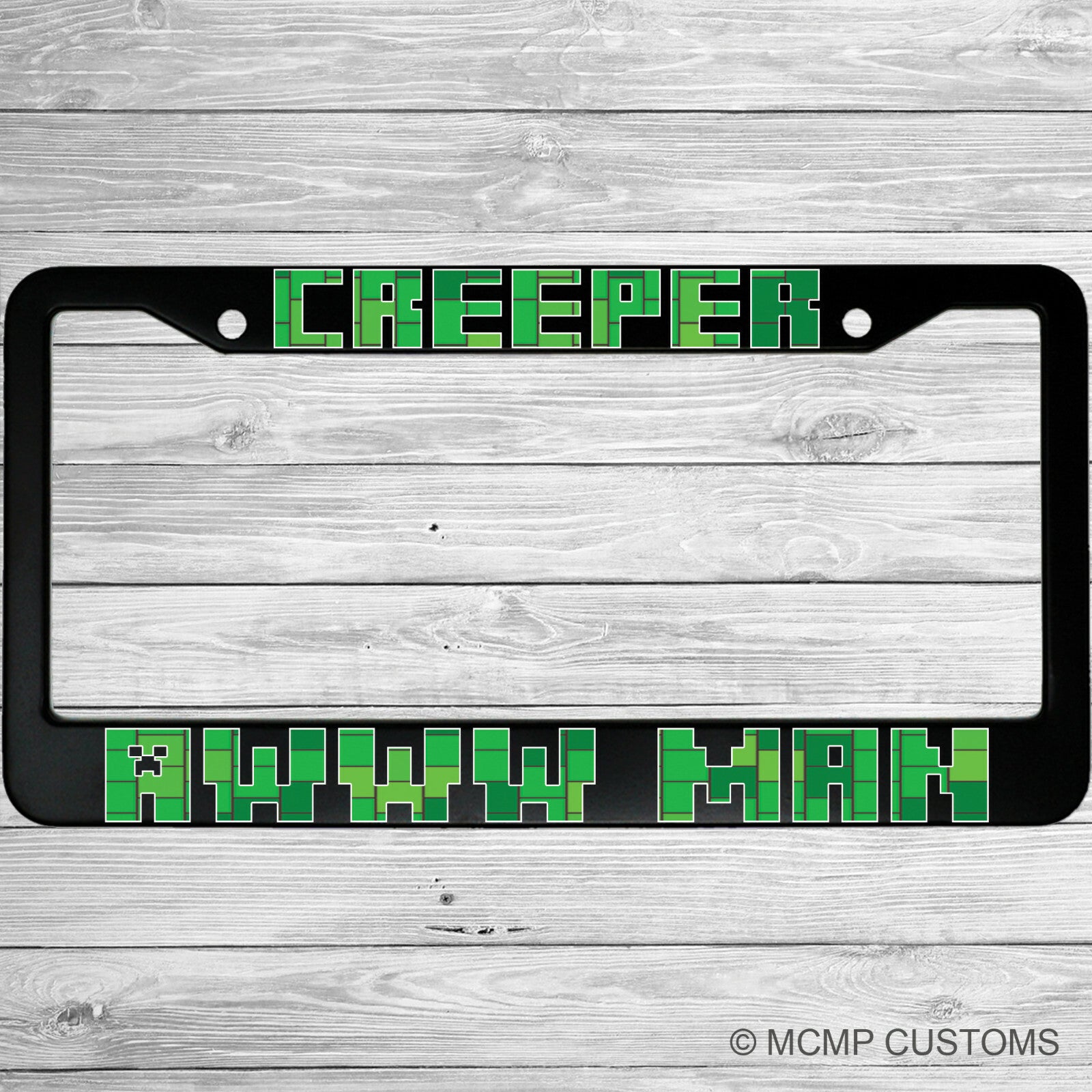 "Creeper Awww Man Minecraft" license plate frame shown on vehicle — lifestyle photo