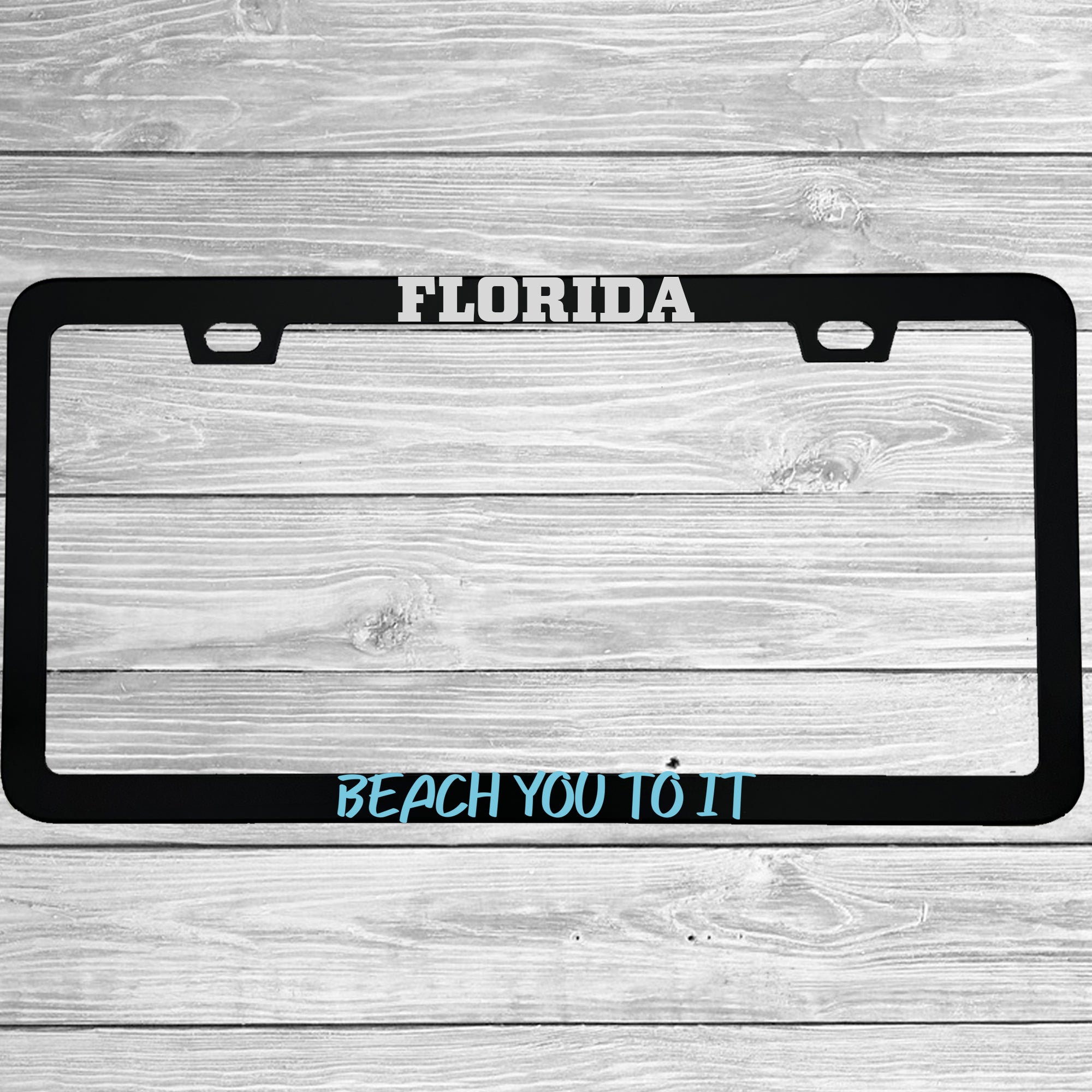 Close-up of "Florida Beach You To It" license plate frame showing fade-proof print quality