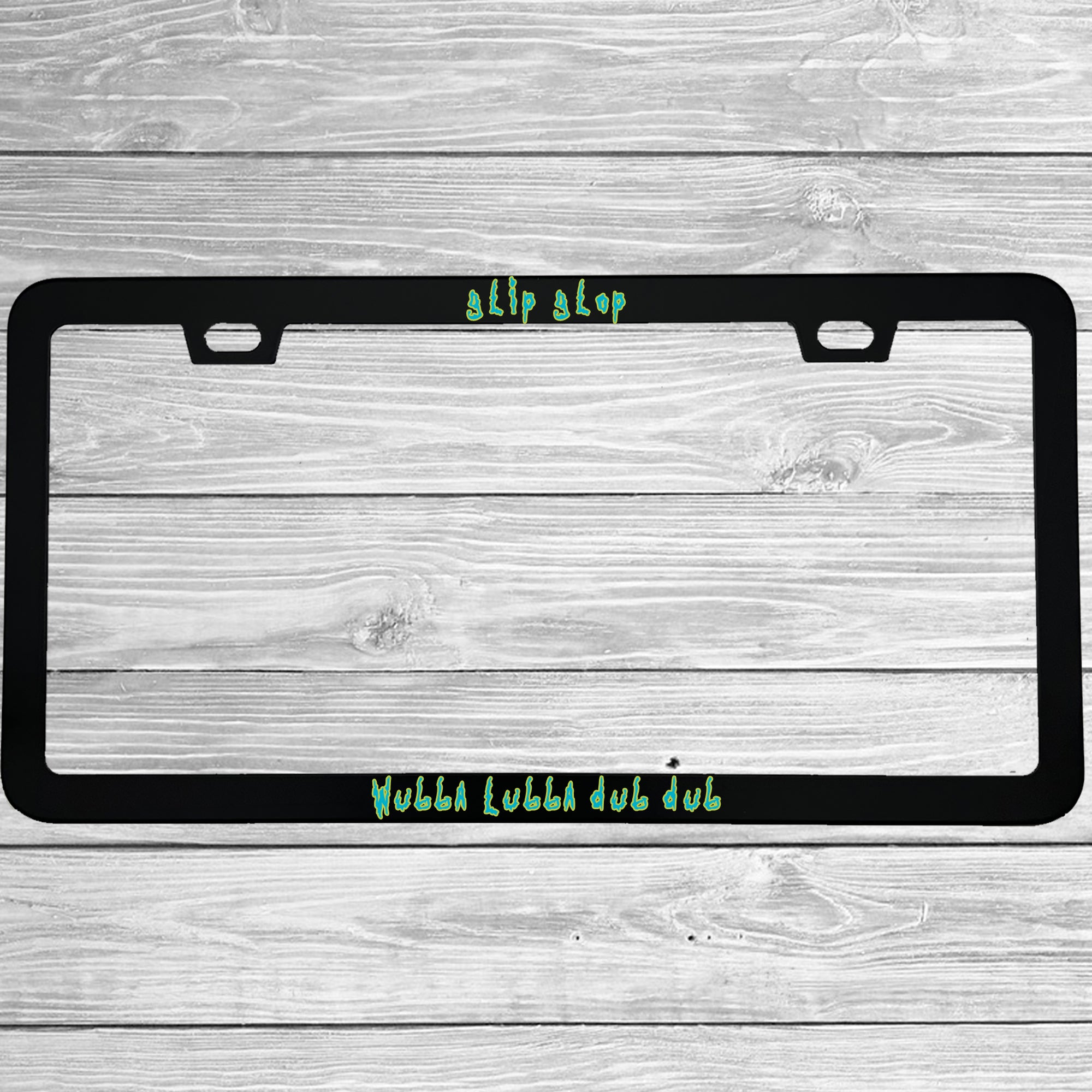 Close-up of "Glip Glop Wubba Lubba Dub Dub" license plate frame showing fade-proof print quality