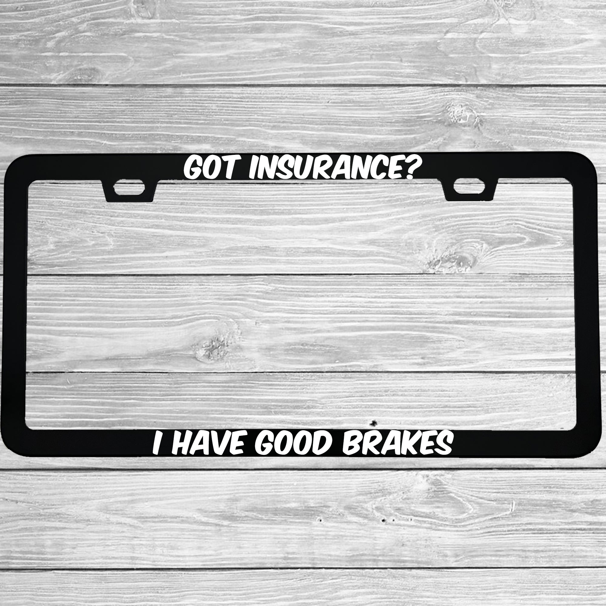 Close-up of "Got Insurance? I Have Good Brakes" license plate frame showing fade-proof print quality
