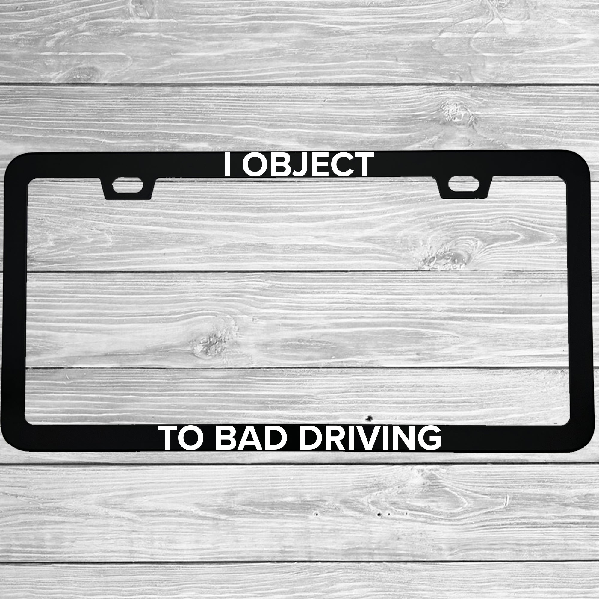 Close-up of "I Object To Bad Driving" license plate frame showing fade-proof print quality