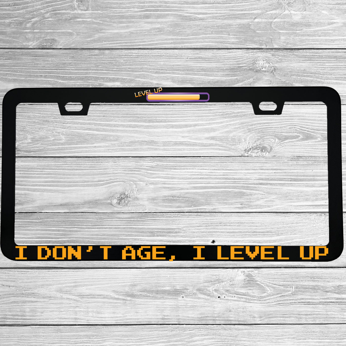 Close-up of "I Dont Age I Level Up" license plate frame showing fade-proof print quality