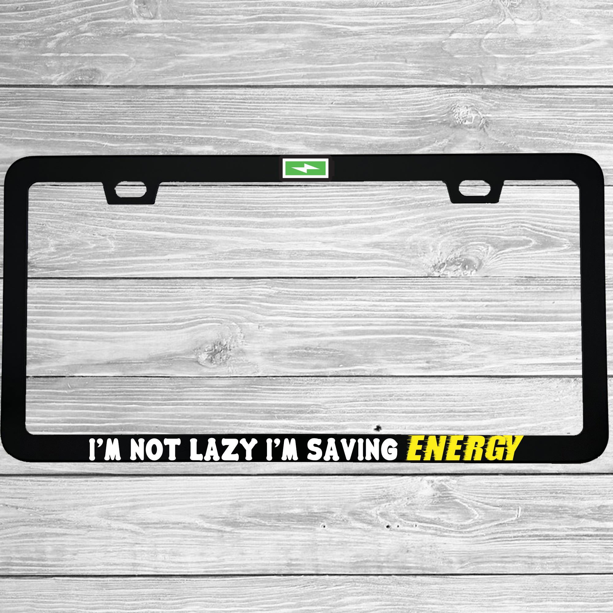 Close-up of "I'm Not Lazy, I'm Saving Energy" license plate frame showing fade-proof print quality