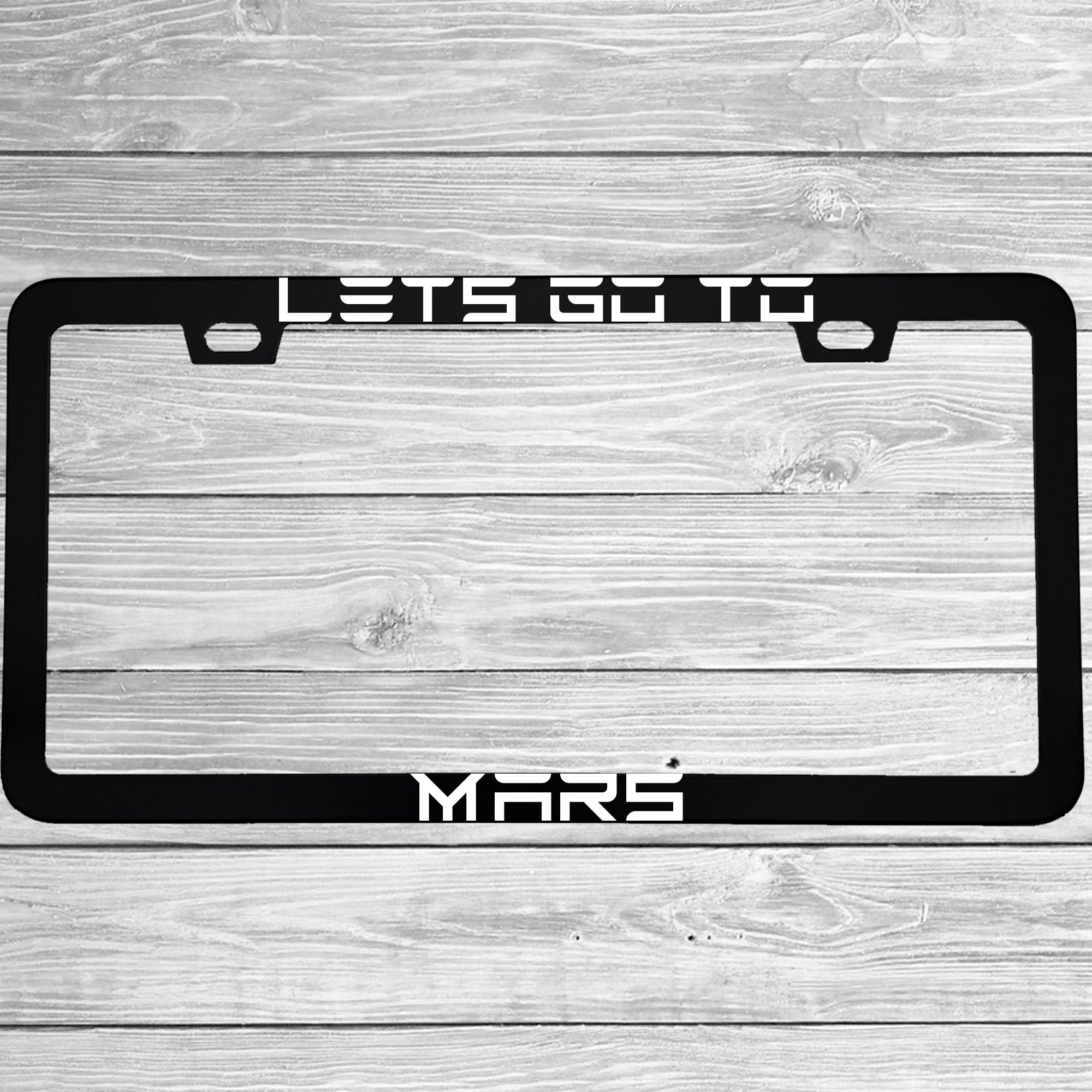 Close-up of "Lets Go To Mars Funny Electric Car Outer Space" license plate frame showing fade-proof print quality