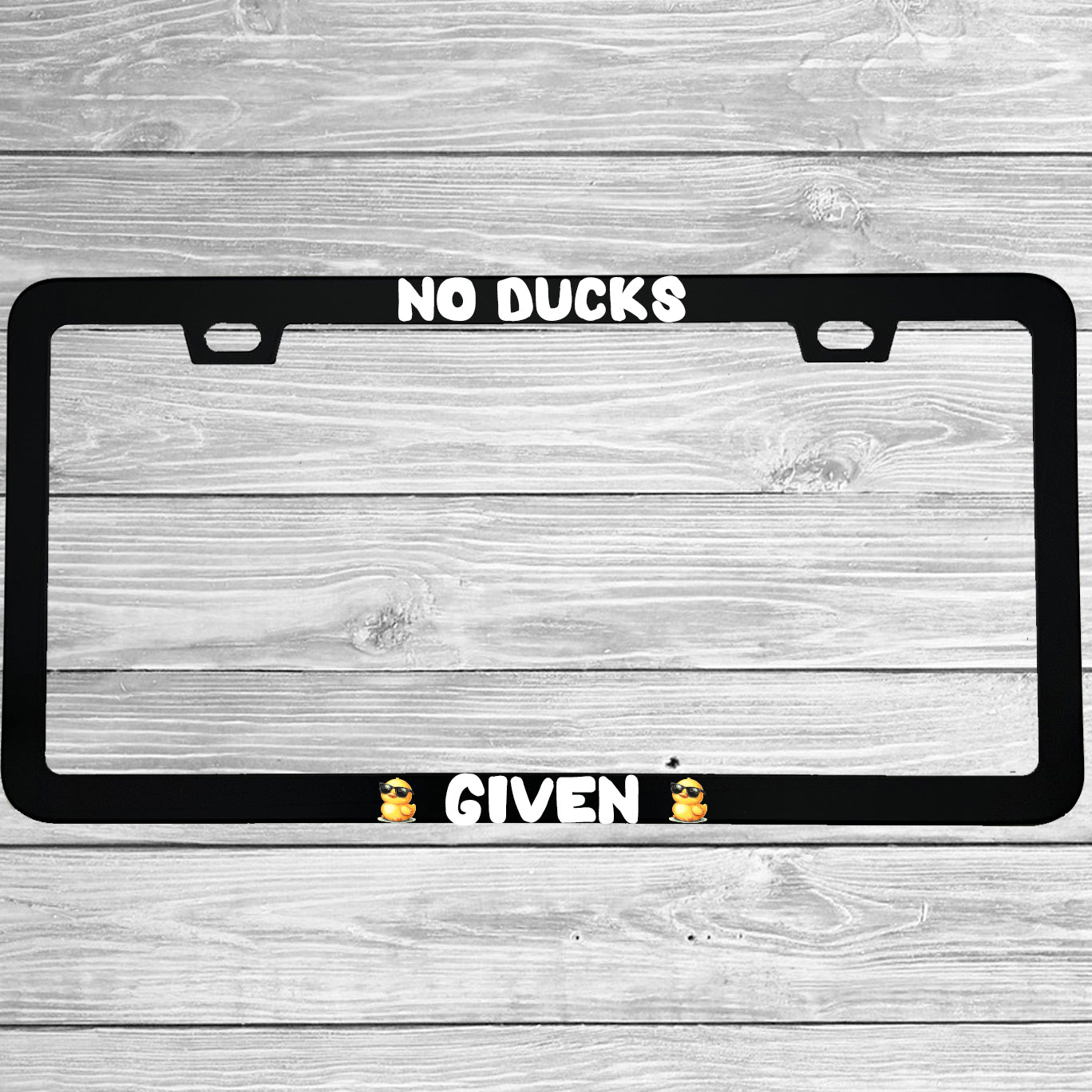 Close-up of "No Ducks Given" license plate frame showing fade-proof print quality