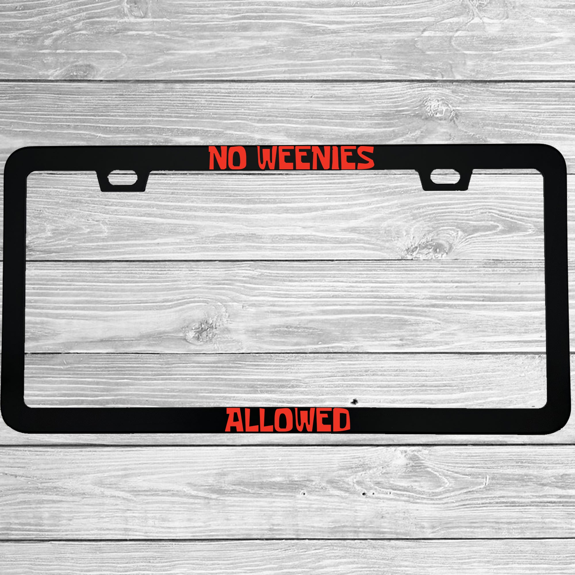 Close-up of "No Weenies Allowed Funny Cartoon" license plate frame showing fade-proof print quality