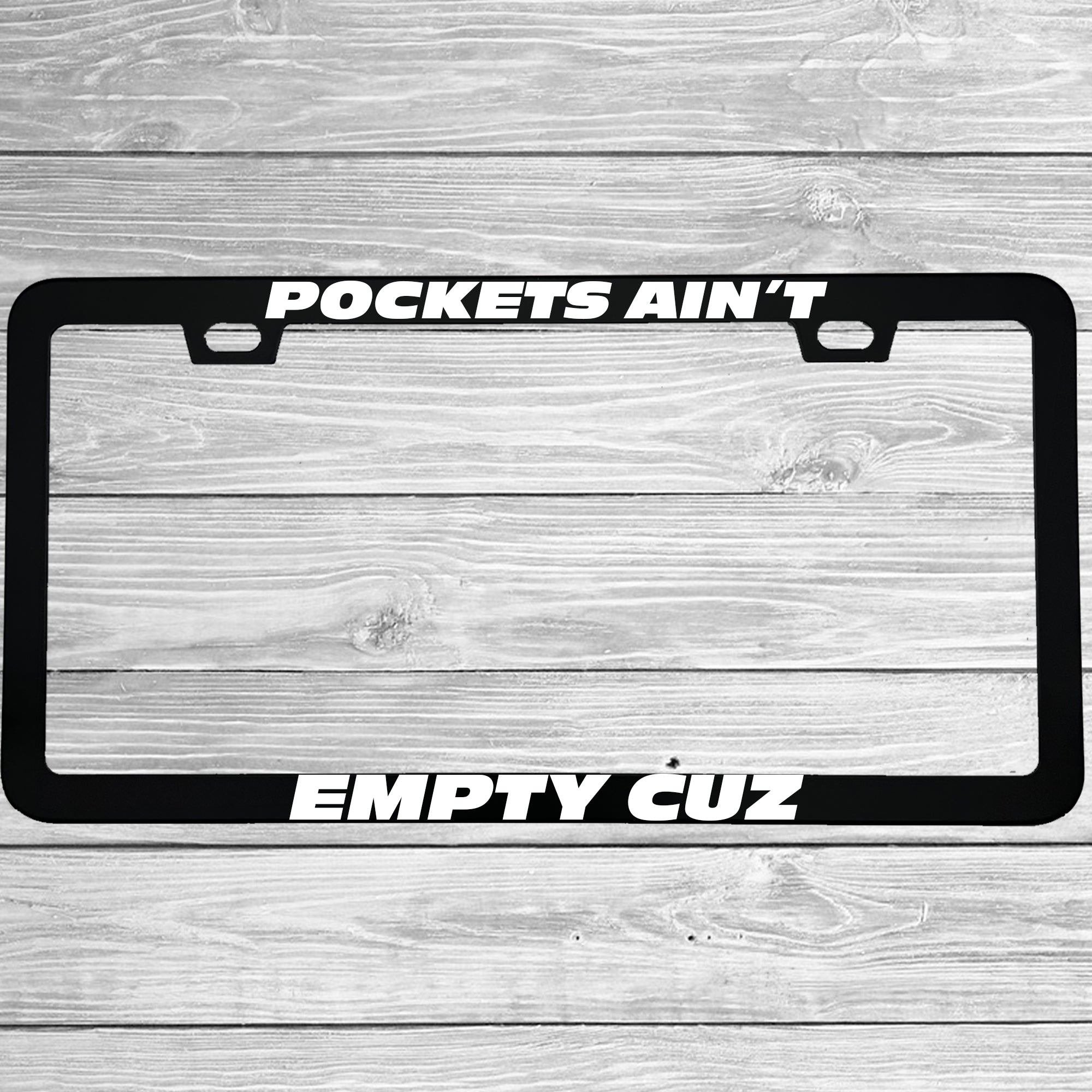 Close-up of "Pockets Ain't Empty Cuz" license plate frame showing fade-proof print quality