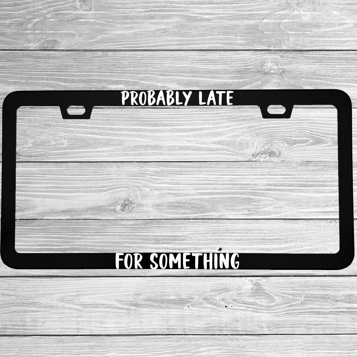 Close-up of "Probably Late For Something" license plate frame showing fade-proof print quality