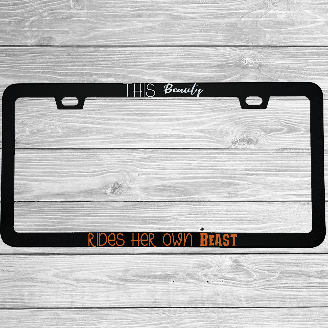 Close-up of "This Beauty Rides Her Own Beast" license plate frame showing fade-proof print quality