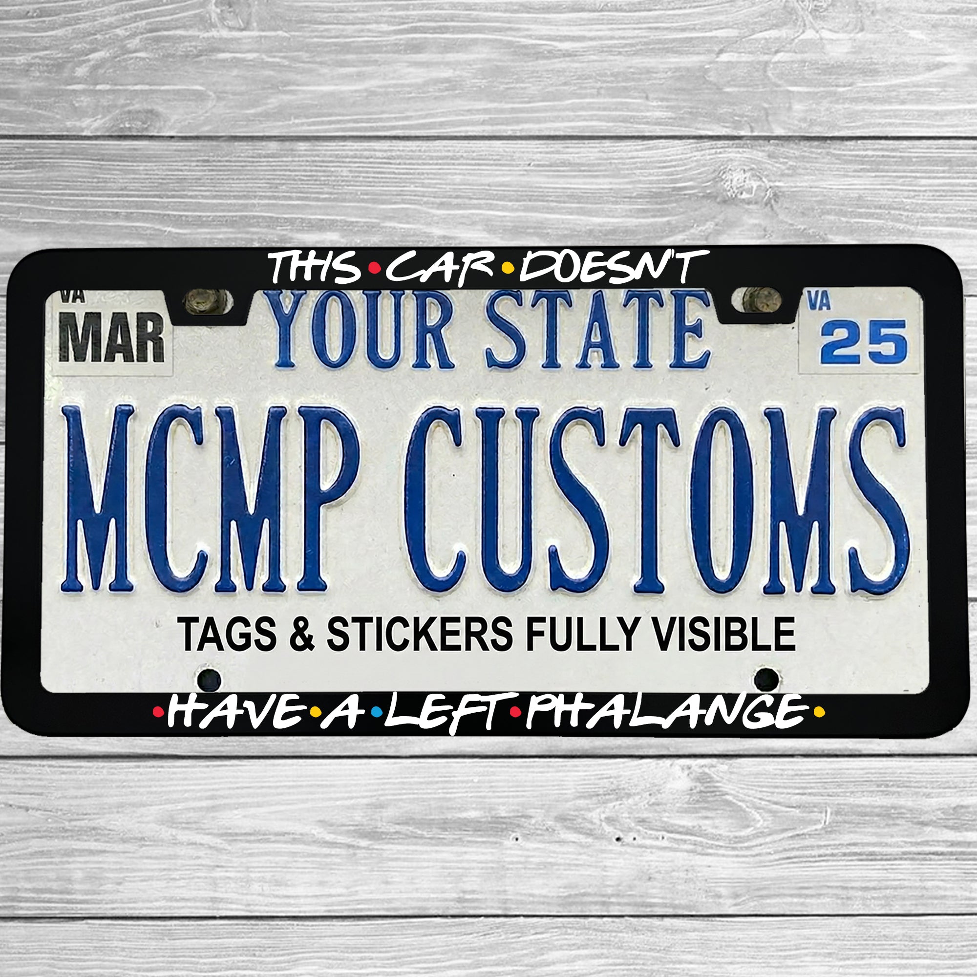 "This Car Doesn't Have A Left Phalange" license plate frame shown on vehicle — lifestyle photo