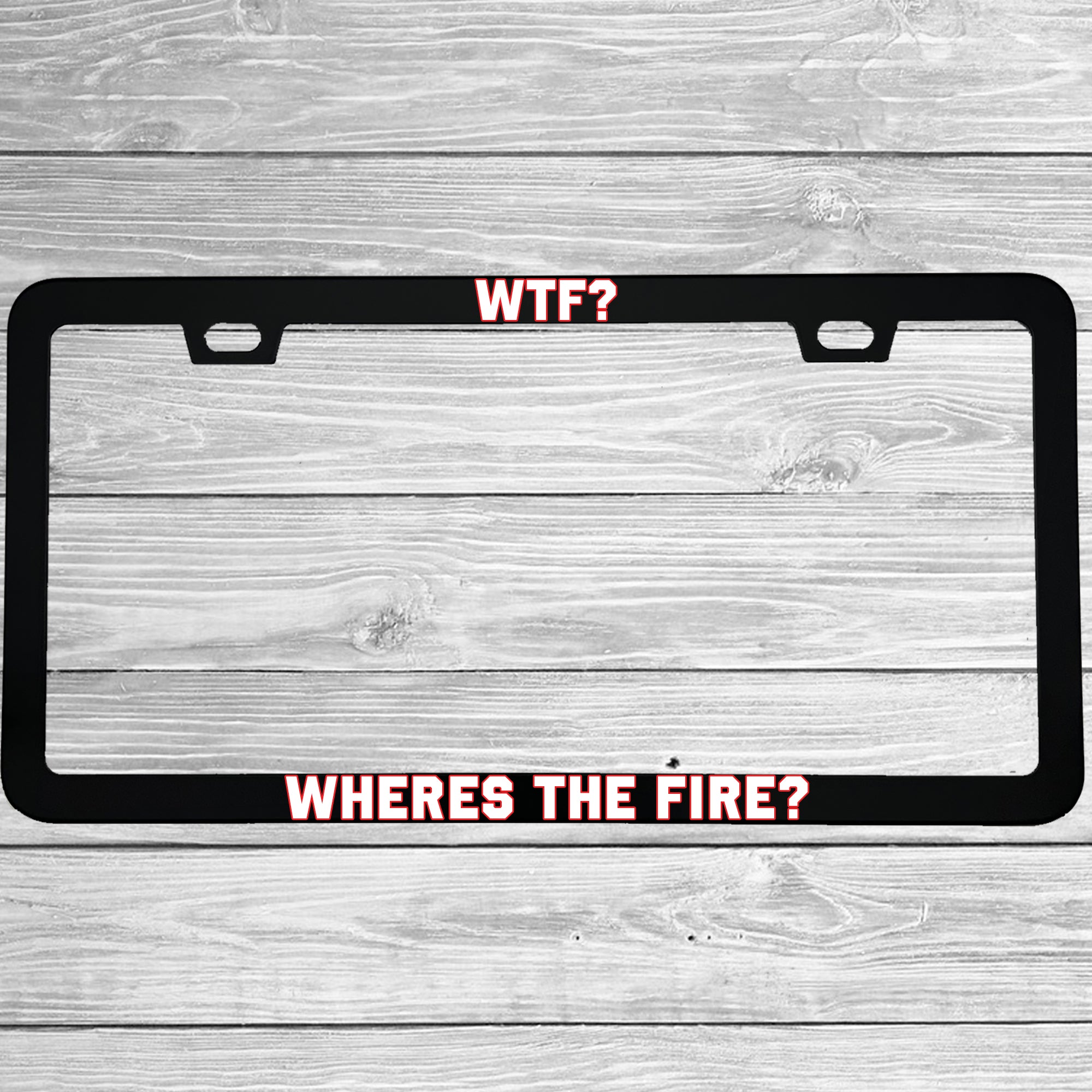 Close-up of "WTF Wheres The Fire" license plate frame showing fade-proof print quality