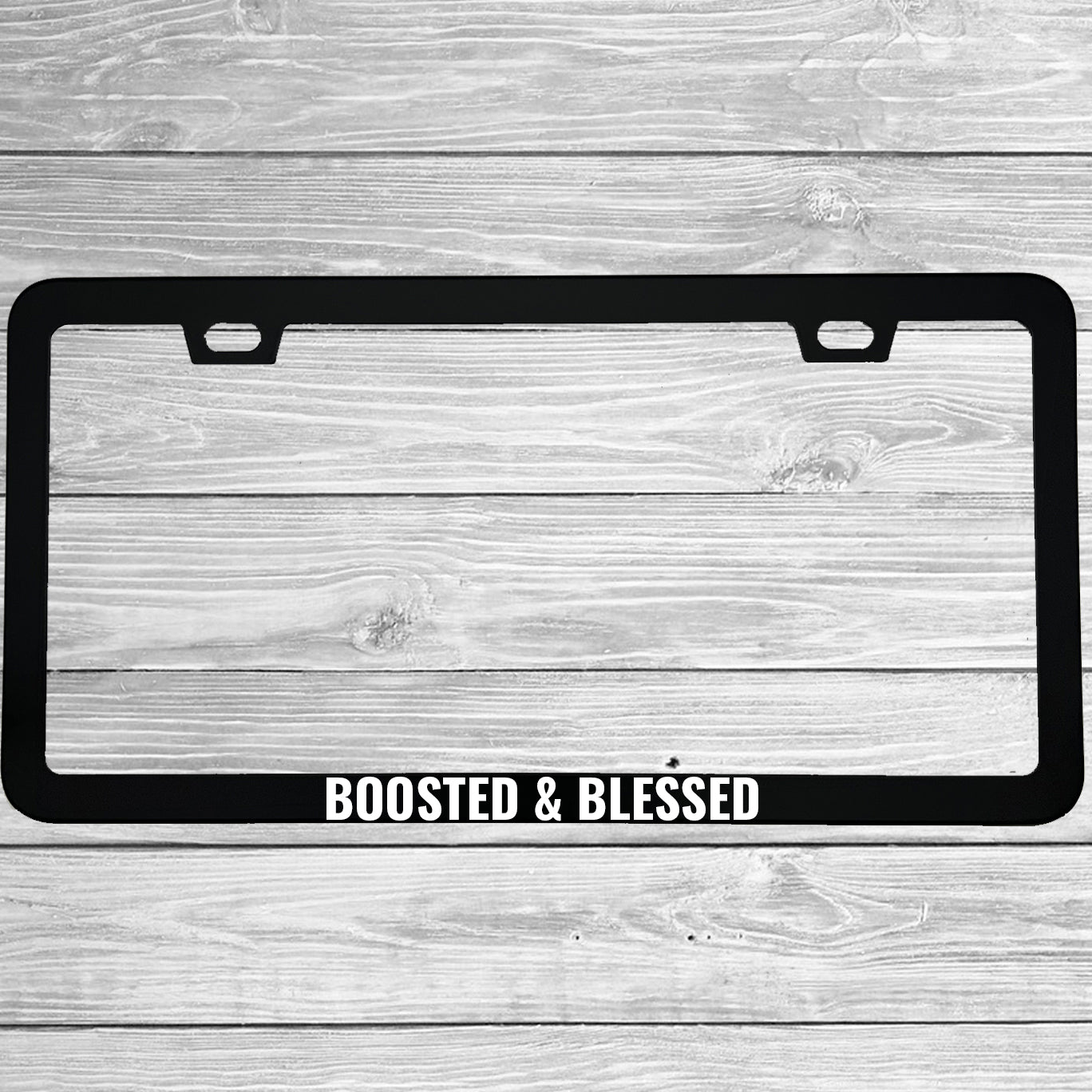 Close-up of "Boosted And Blessed" license plate frame showing fade-proof print quality