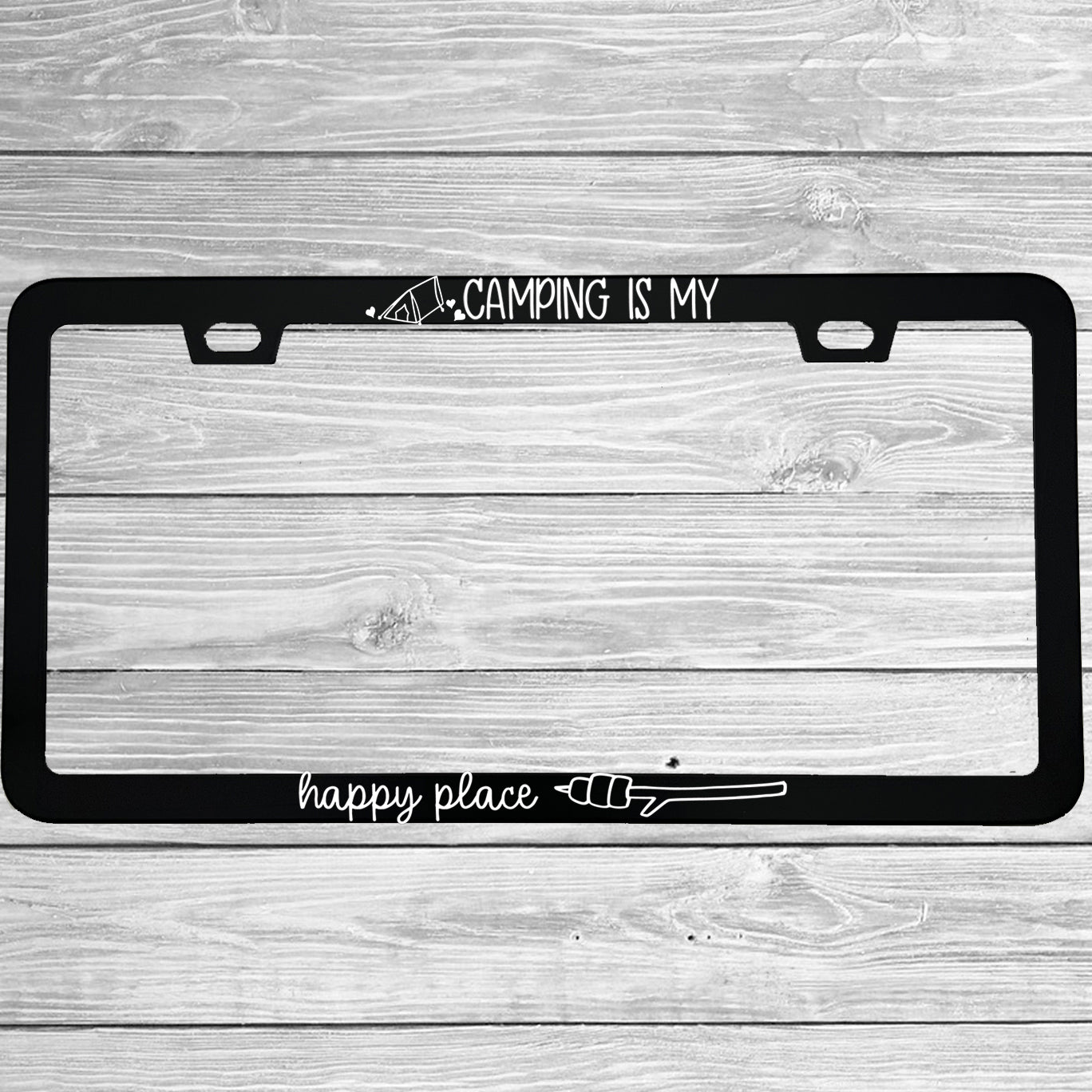 "Camping Is My Happy Place" license plate frame shown on vehicle — lifestyle photo