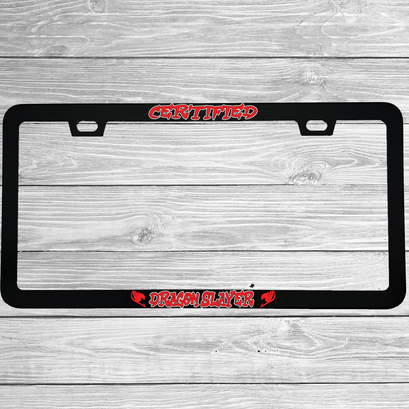 Close-up of "Certified Dragon Slayer" license plate frame showing fade-proof print quality