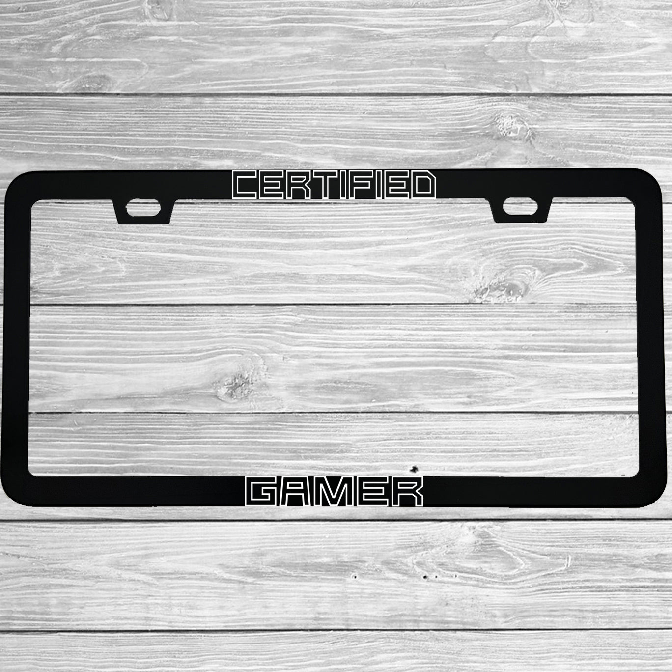 Close-up of "Certified Gamer" license plate frame showing fade-proof print quality