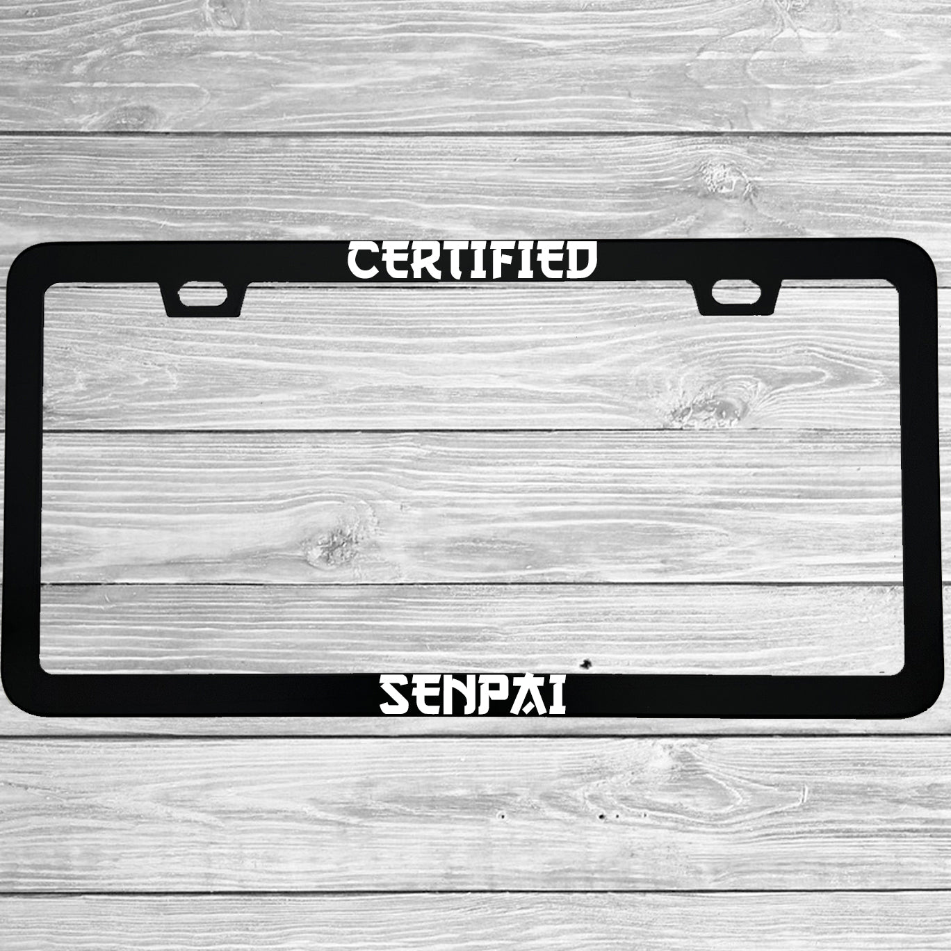 Close-up of "Certified Senpai" license plate frame showing fade-proof print quality