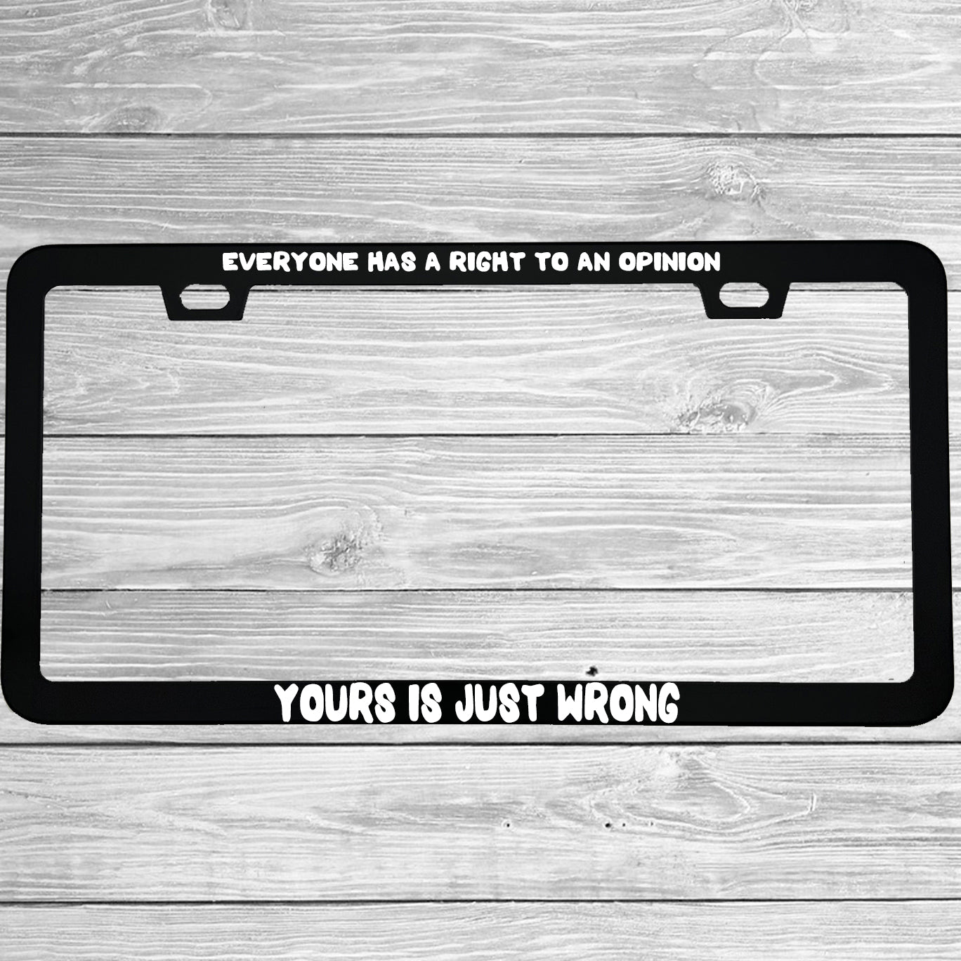 Close-up of "Everyone Has A Right To An Opinion Yours Is Just Wrong" license plate frame showing fade-proof print quality